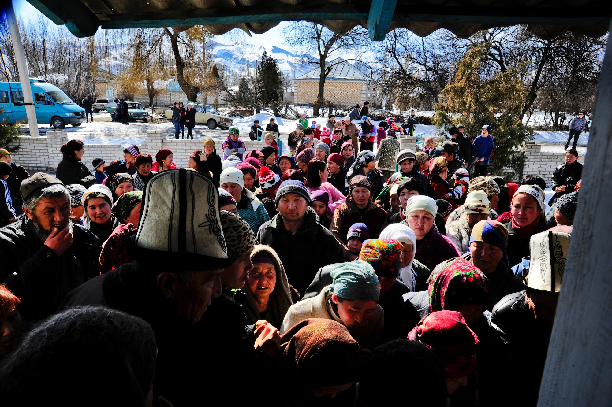 Kyrgyz Republic citizens wait at the entrance of a community center in Kizil Arik village, Kyrgyzstan, for the opportunity to receive a coat during an Operation Warm and Dry distribution March 9, 2012. More than 280 families of the village received blankets or coats. (U.S. Air Force Photo/Staff Sgt. Angela Ruiz)