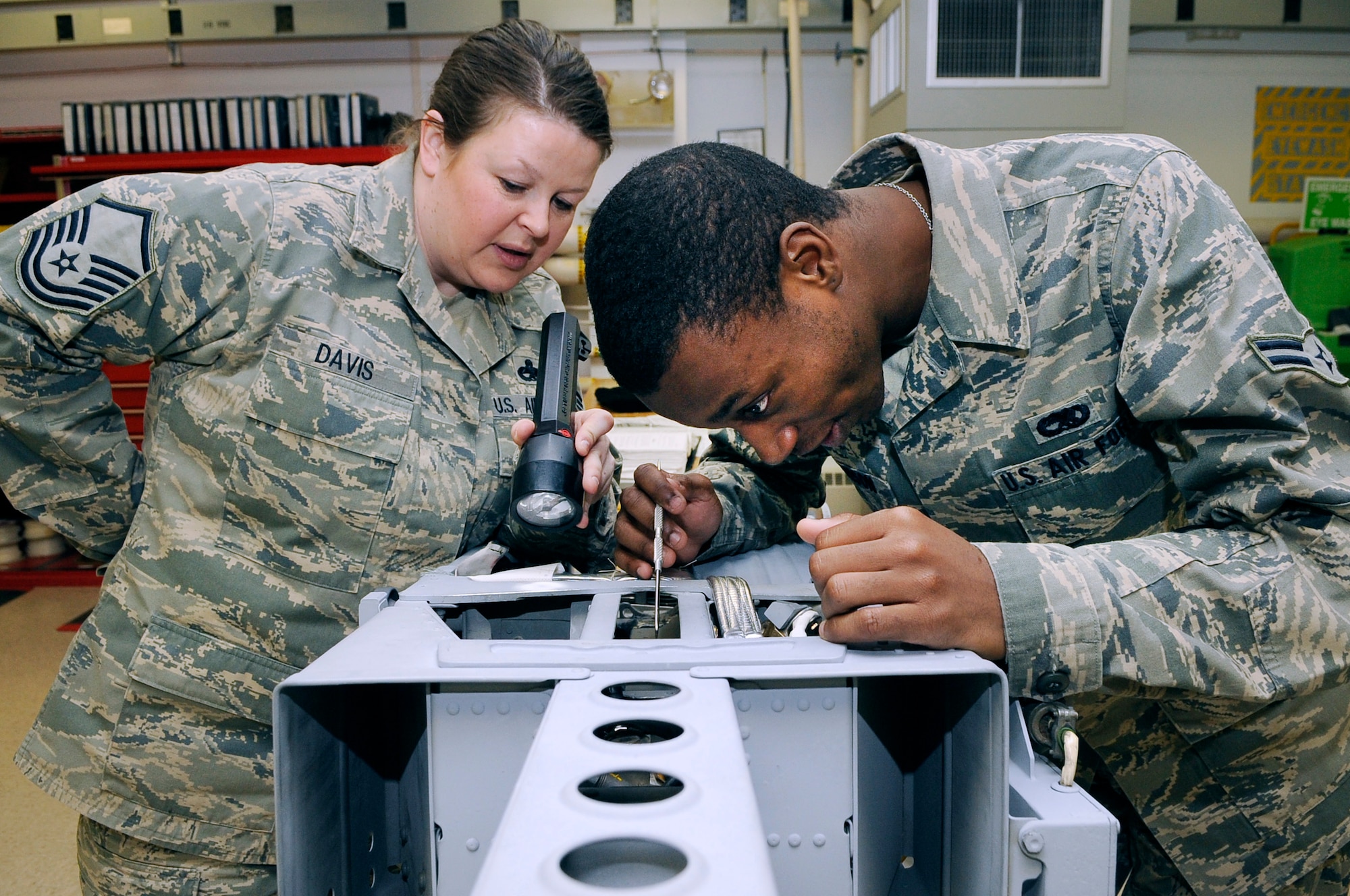 U.S. Air Force Master Sgt. Becky Davis, 354th Maintenance Squadron egress section chief, and Airman 1st Class William Harrison, 354th Maintenance Squadron egress apprentice, repair deficiencies on an F-16 Fighting Falcon Advance Concept Ejection Seat II March 9, 2012, Eielson Air Force Base, Alaska. Once clear of an aircraft, the ACES II is capable of automatically sensing egress conditions and mortar-deploying its main chute in less than 2 seconds. (U.S. Air Force photo/Staff Sgt. Jim Araos)