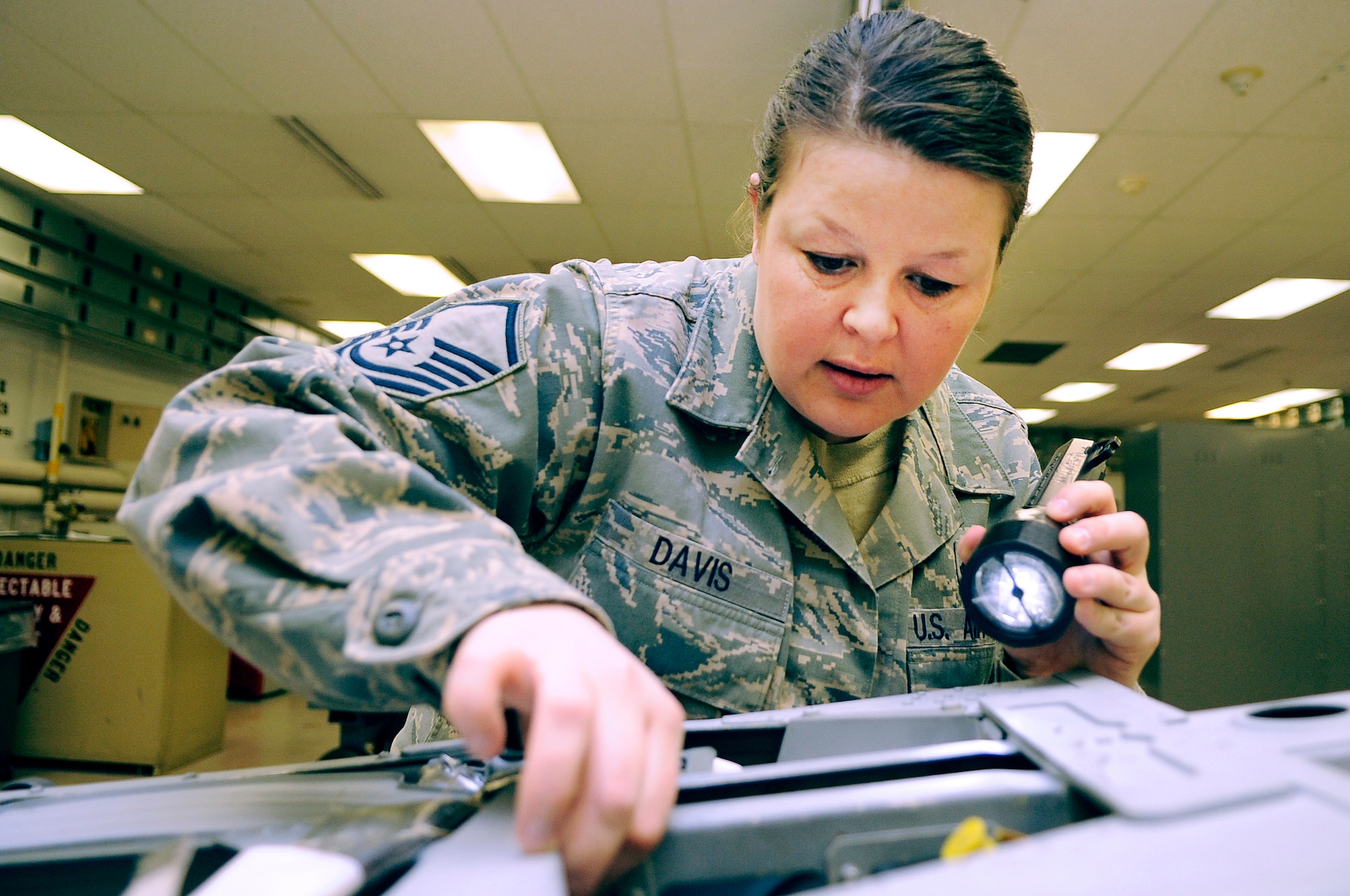 U.S. Air Force Master Sgt. Becky Davis, 354th Maintenance Squadron egress section chief, inspects an F-16 Fighting Falcon Advance Concept Ejection Seat II March 9, 2012, Eielson Air Force Base, Alaska. Davis will inspect for cracks, contamination, corrosion and the correct routing of hoses to ensure to proper function in the event of an in-flight emergency. (U.S. Air Force photo/Staff Sgt. Jim Araos)