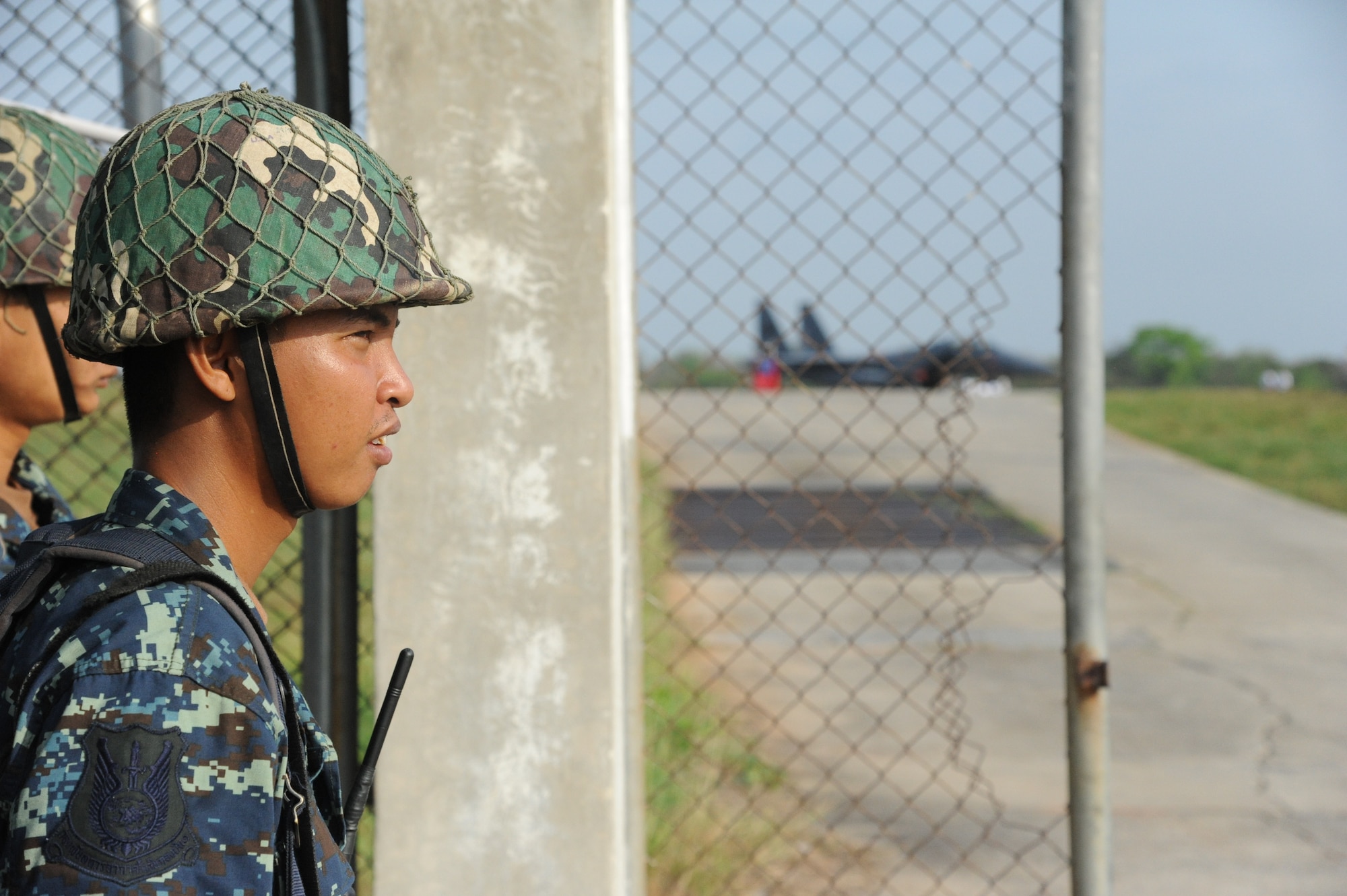 A Royal Thai Air Force security forces airman guards an entry control point at Korat Royal Thai Air Force Base, Thailand, Mar. 12. The Airman is with more than 1,600 personnel participating in Cope Tiger 2012, a large force air employment trilateral exercise between the Royal Thai Air Force, Republic of Singapore Air Force and U.S.  Air Force. The exercise is designed to enhance readiness and combined/joint interoperability between U.S. Forces, allies and partners in the Asia-Pacific region. (U.S. Air Force photo/Capt David Herndon)