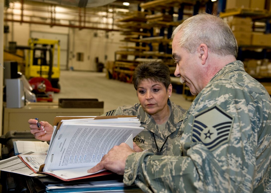 JOINT BASE ELMENDORF-RICHARDSON, Alaska - Master Sgt. Paul Jenkins from the Alaska National Guard's 176 Logistics Readiness Squadron and Chief Master Sgt. Sharon Ervin, a logistics compliance assessment program inspector from Florida Air National Guard's 125 Fighter Wing review paperwork here pertaining to the 176 Wing's weapons' vault March 5, 2012. 

Ervin was here as a part of an Air National Guard team of inspectors for the 176 Wing logistics compliance assessment. The assessment is to provide leadership at all levels with an evaluation of a unit's ability to perform key logistics processes in a safe, standardized, repeatable, and technically compliant manner. National Guard photo by Master Sgt Shannon Oleson
