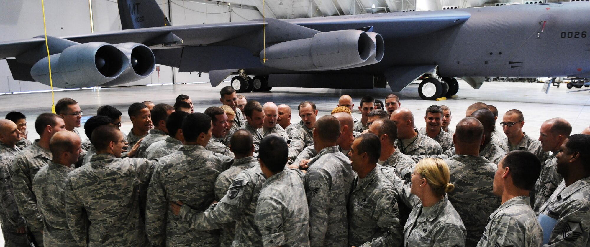 ANDERSEN AIR FORCE BASE, Guam- Members of the 23rd Expeditionary Aircraft Maintenance Unit huddle together with the Senior Enlisted Leaders for morale during a site visit, Mar. 8. During the visit they met with deployed and permanent party Airmen, getting to know the mission and everyone involved.(U.S. Air Force photo/Senior Airman Carlin Leslie)