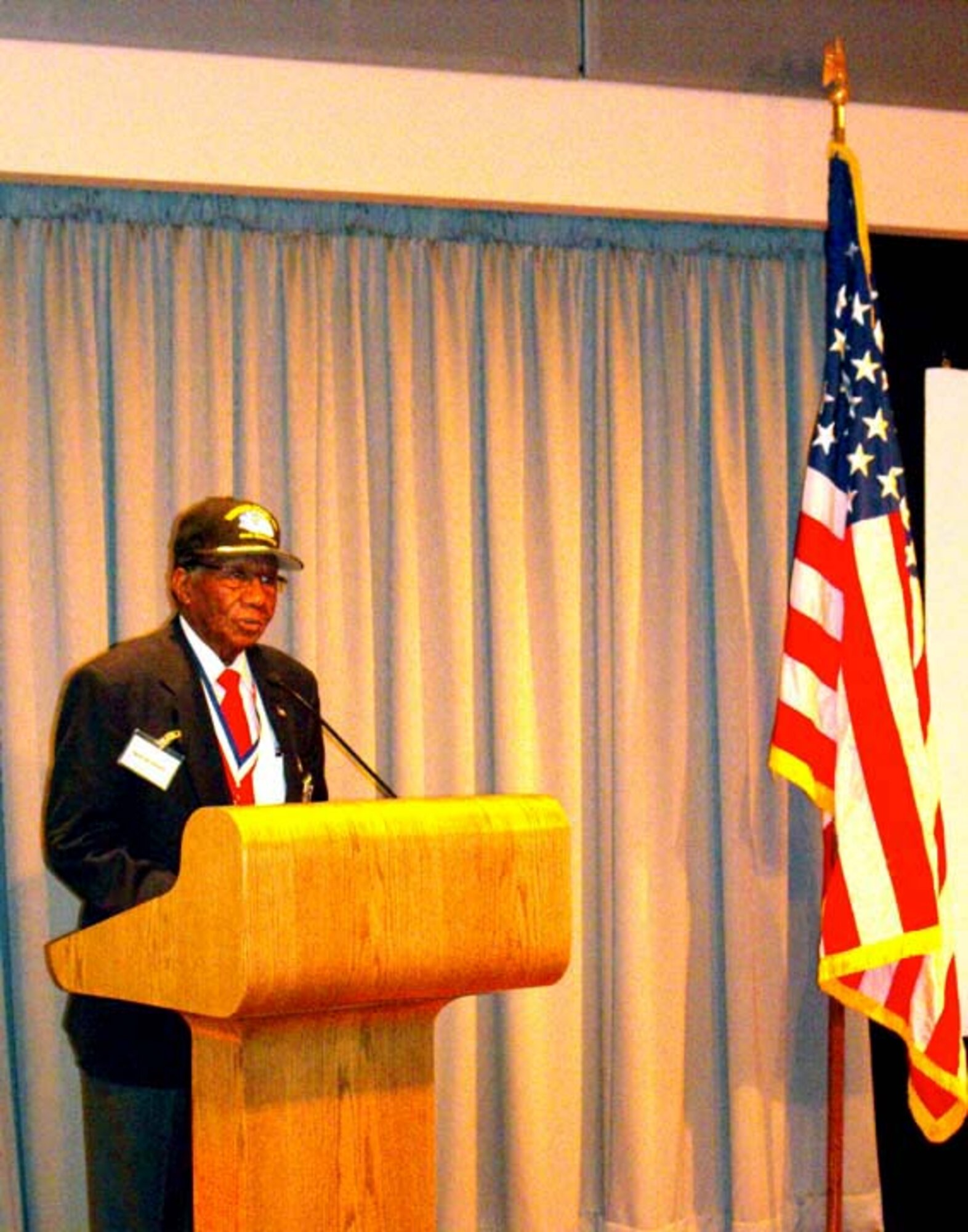 Buford A. Johnson, retired U.S. Air Force crew chief and member of the Buford A. Johnson (CA) Chapter of Tuskegee Airmen, Inc., addresses a black history luncheon audience Feb. 28, 2012, at the Defense Media Activity-Riverside. Johnson was a member of the original Tuskegee Airmen group that fought in World War II, and he is one of the last few surviving members who regularly tour and speak on their experiences. (Photo by Navy Mass Communication Specialist Seaman William S. Gaskill)