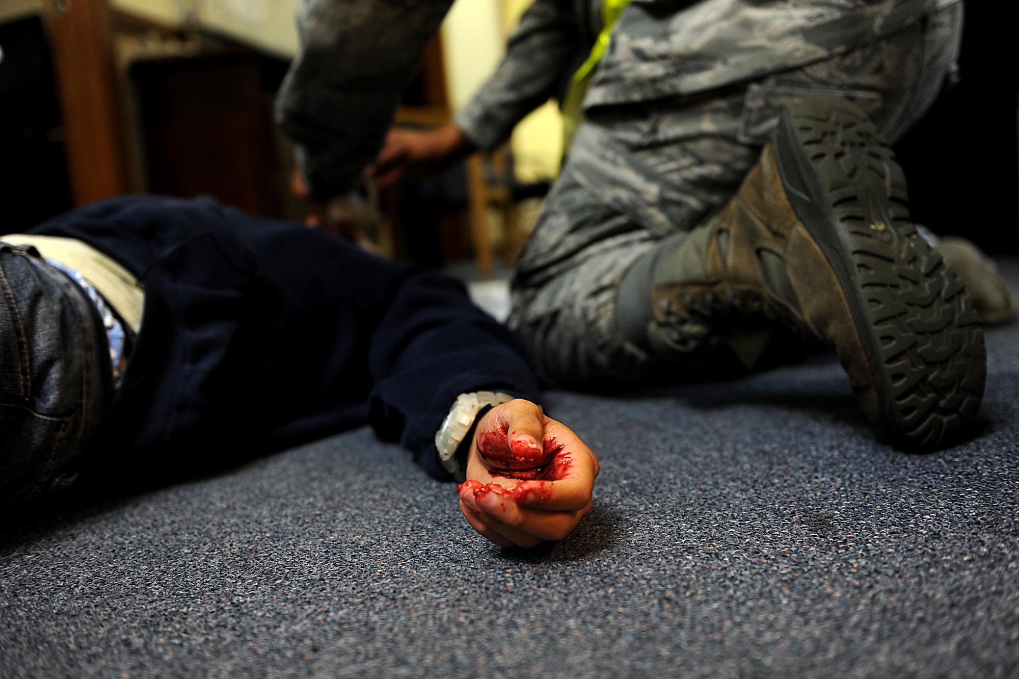 U.S. Air Force Senior Airman Anthony Augustine's, 961st Airborne Air Control Squadron, lies patiently covered in fake blood during a training scenario for local operational readiness exercise Beverly High 12-3 on Kadena Air Base, March 12, 2012. LOREs give Airmen the opportunity to train in a safe environment and prepare for real world contingencies. (U.S. Air Force photo by Airman 1st Class Brooke P. Beers/Released)