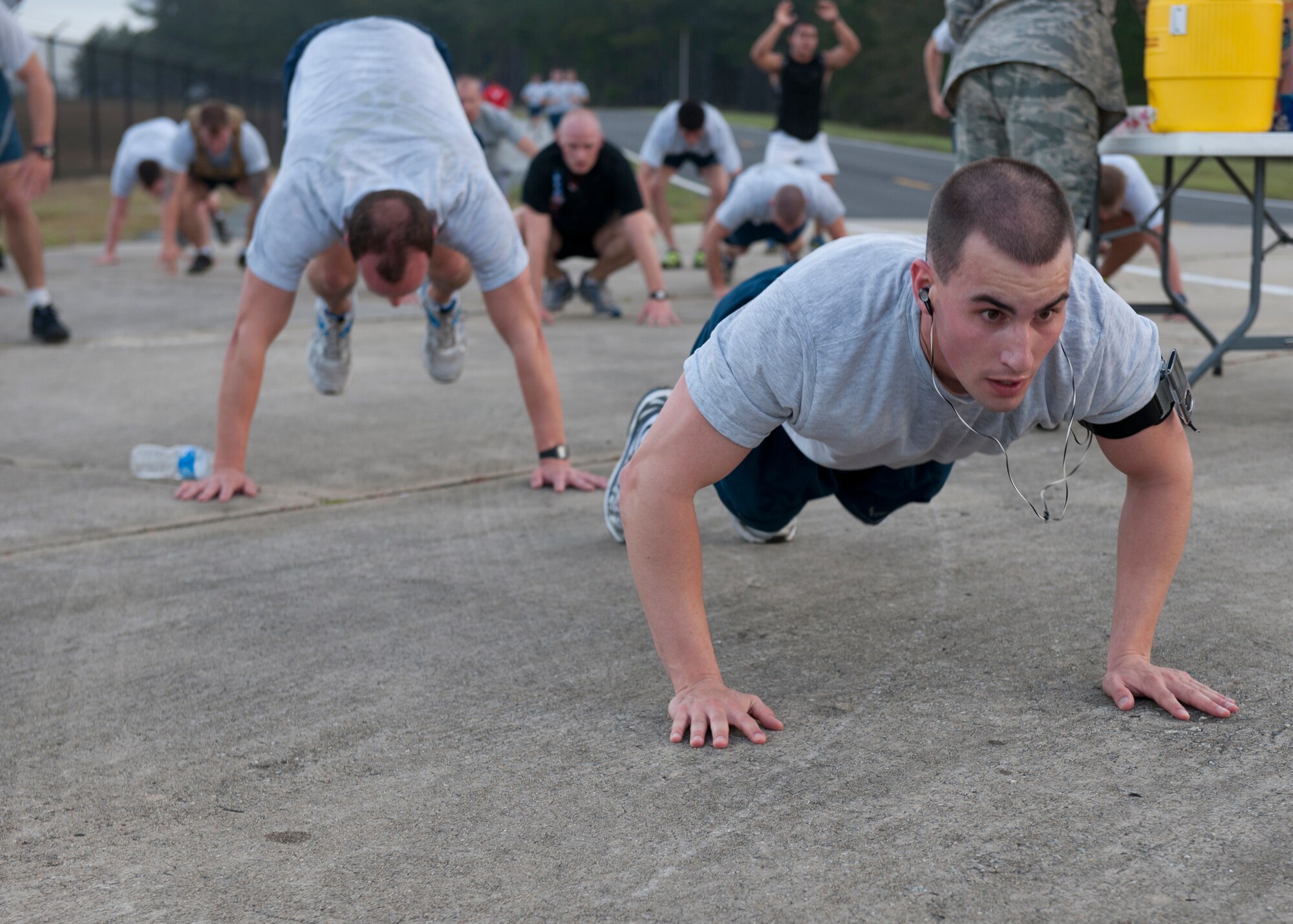 Airmen participating in the Senior Airman Jason D. Cunningham Memorial 10K Workout push through workouts coordinated by the Airman Leadership School to honor the passing of Cunningham 10 years ago at Moody Air Force Base, Ga., Mar. 9, 2012. Ten  different workout stations were set up along the run. Participants completed 26 repetitions at each stationed which represented the age of Cunningham when he passed away. (U.S. Air Force photo by Senior Airman Eileen Meier/Released)