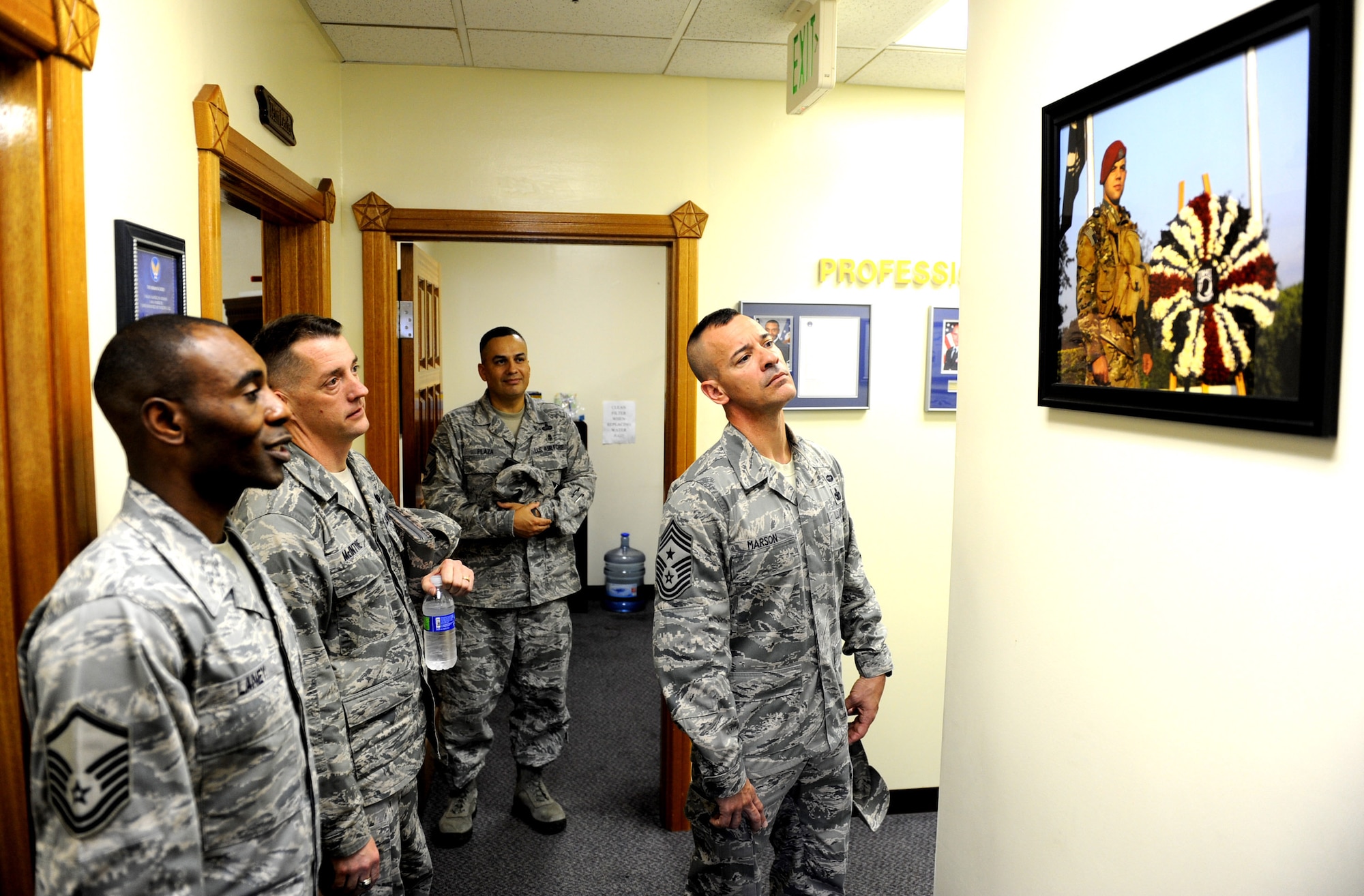 U.S. Air Force Master Sgt. Jerry Laney (left), base career assistance advisor, describes a painting to Chief Master Sgts. Douglas McIntyre, 5th Air Force command chief, William Plaza, 18th Force Support Squadron superintendent, and Mark Marson, 18th Wing command chief at the McDaniel Center on Kadena Air Base, Japan, March 9, 2012. The McDaniel Center is home to Team Kadena's First Term Airmen Center, Career Assistant Advisors and other Professional Development programs.(U.S. Air Force photo by Airman 1st Class Justin Veazie/released)