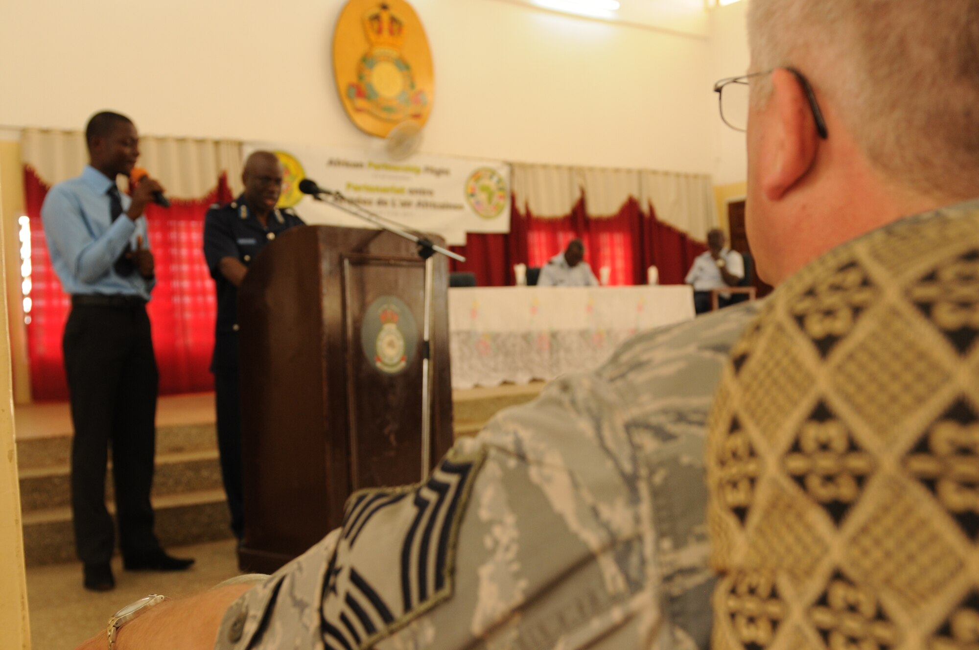 ACCRA, Ghana -- Chief Master Sgt. Douglas Faldet, 119th Wing component maintenance flight chief, listens as Air Commodore Emanuel Ahadome, Ghana air officer, director of logistics speaks of the importance of the first African Partnership Flight during the APF's opening ceremonies March 12 here. APF is a two week military-to-military multilateral and regional engagement event involving the partnership of U.S., Benin, Ghanaian, Nigerian, Togolese, and Senegalese air forces. . The partnerships aim to increase air safety and security for the region through the exchange of ideas and techniques between all countries involved in the event. (U.S. Air Force photo by Senior Airman Natasha Stannard/Released)