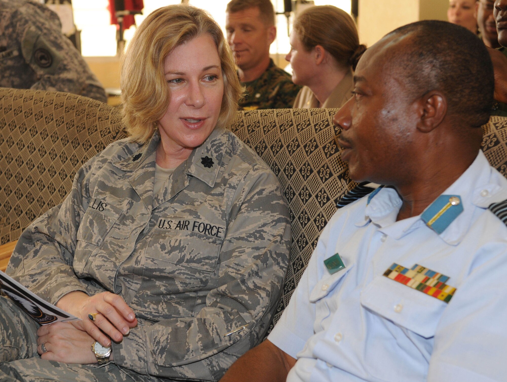 ACCRA, Ghana -- U.S. Air Force Lt. Col. Melanie Ellis, U.S. Air Forces in Europe Surgeon General medical support officer, speaks with Ghanaian Air Force Group Capt. Julius Dzamefe, GAF headquarters director of supply, before the first African Partnership Flight's opening ceremonies March 12 here. APF is a two week military-to-military multilateral and regional engagement event involving the partnership of U.S., Benin, Ghanaian, Nigerian, Togon, and Senegalian air forces. The partnerships aim to increase air safety and security for the region through the exchange of ideas and techniques between all countries involved in the event. (U.S. Air Force photo by Senior Airman Natasha Stannard/Released)