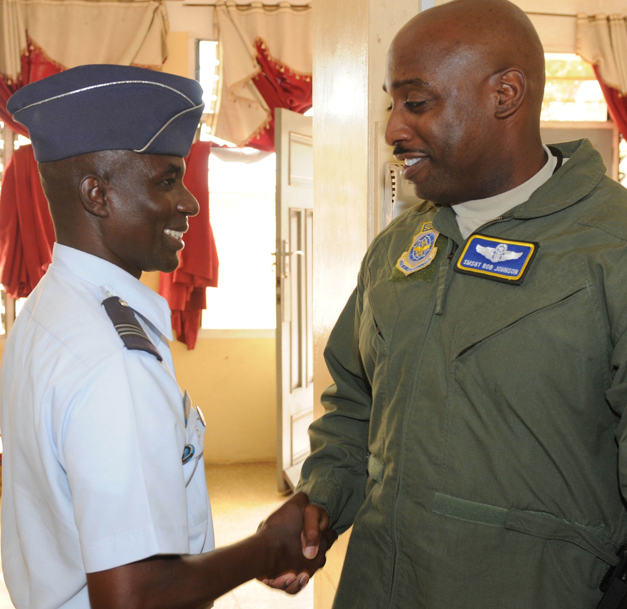ACCRA, Ghana -- Ghanaian Air Force Flight Lt. Baba-Mubarak Ahmadu, GAF School of Trade Training chief instructor, left, meets with U.S. Air Force Senior Master Sgt. Rob Johnson, 818th Mobility Support Advisory Squadron, before the opening ceremonies of the first African Partnership Flight March 12  here. APF is a two week military-to-military multilateral and regional engagement event involving the partnership of U.S., Benin, Ghanaian, Nigerian, Togon, and Senegalian air forces. The partnerships aim to increase air safety and security for the region through the exchange of ideas and techniques between all countries involved in the event. (U.S. Air Force photo by Senior Airman Natasha Stannard/Released)