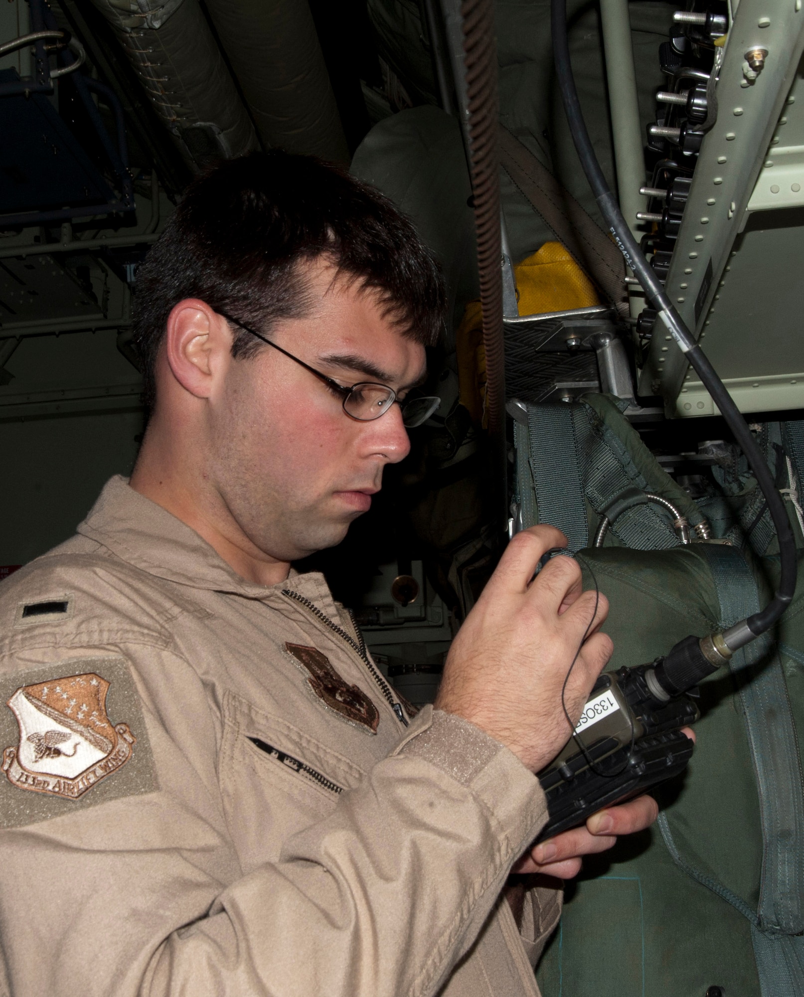 A C-130 H3 pilot with the 133rd Airlift Wing programs radios in the cargo area of a “Hercules” prior to takeoff. Over thirty Minnesota Air National Guard members deployed to Afghanistan in support of Operation Enduring Freedom on Mar. 11, 2012, from the Air Guard base at the Minneapolis – St. Paul international airport. USAF official photo by Tech. Sgt. Erik Gudmundson