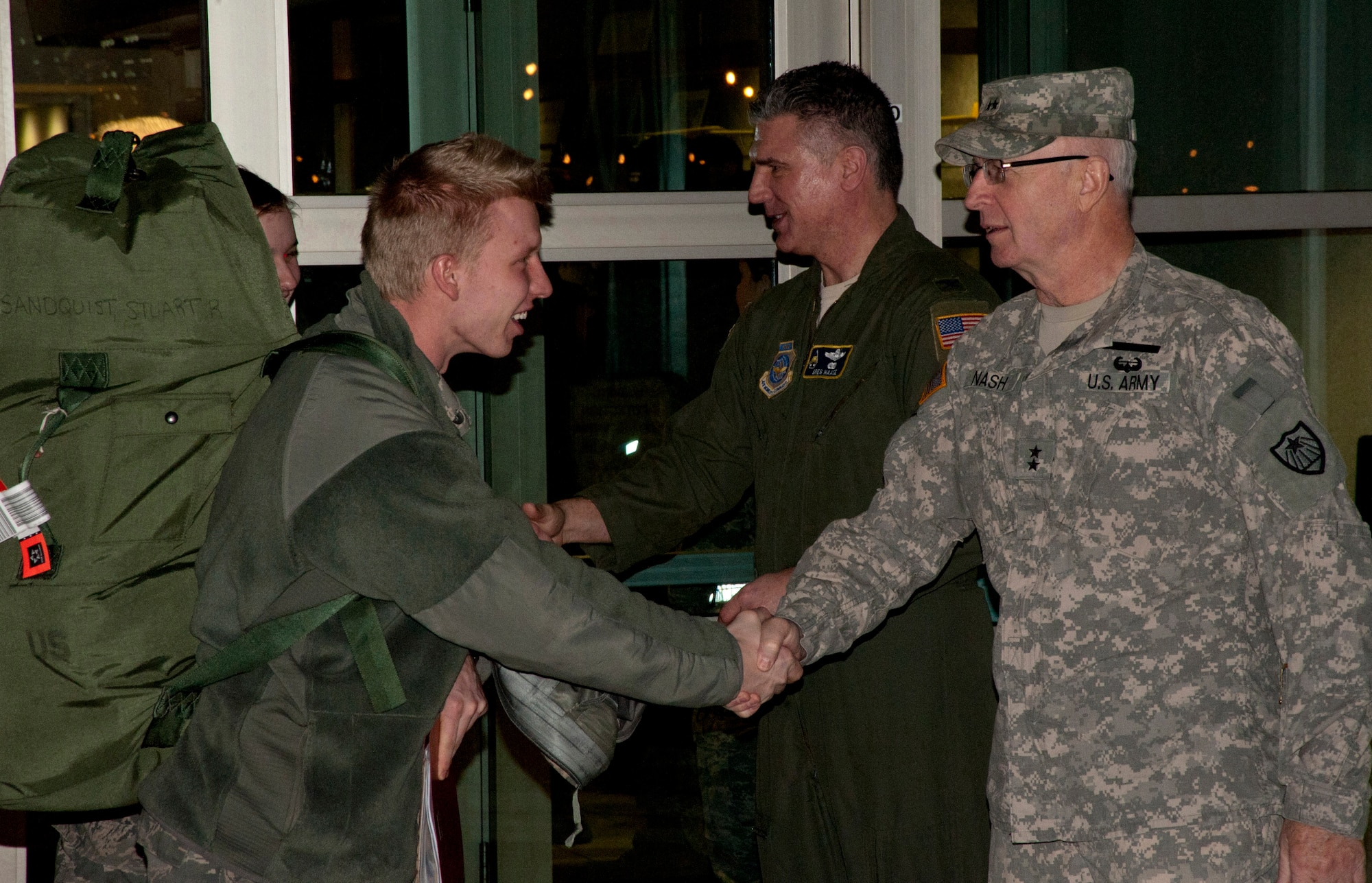 Minnesota National Guard Adjutant General, Maj. Gen. Rick Nash, and Col. Greg Haase, commander of the 133rd Airlift Wing take turns shaking hands with Airman of the 133rd Airlift Wing as they deploy to Afghanistan in support of Operation Enduring Freedom Mar. 11, 2012. About thirty Airmen departed in the early morning from the St. Paul Air National Guard base at the Minneapolis – St. Paul international airport. USAF official photo by Tech. Sgt. Erik Gudmundson
