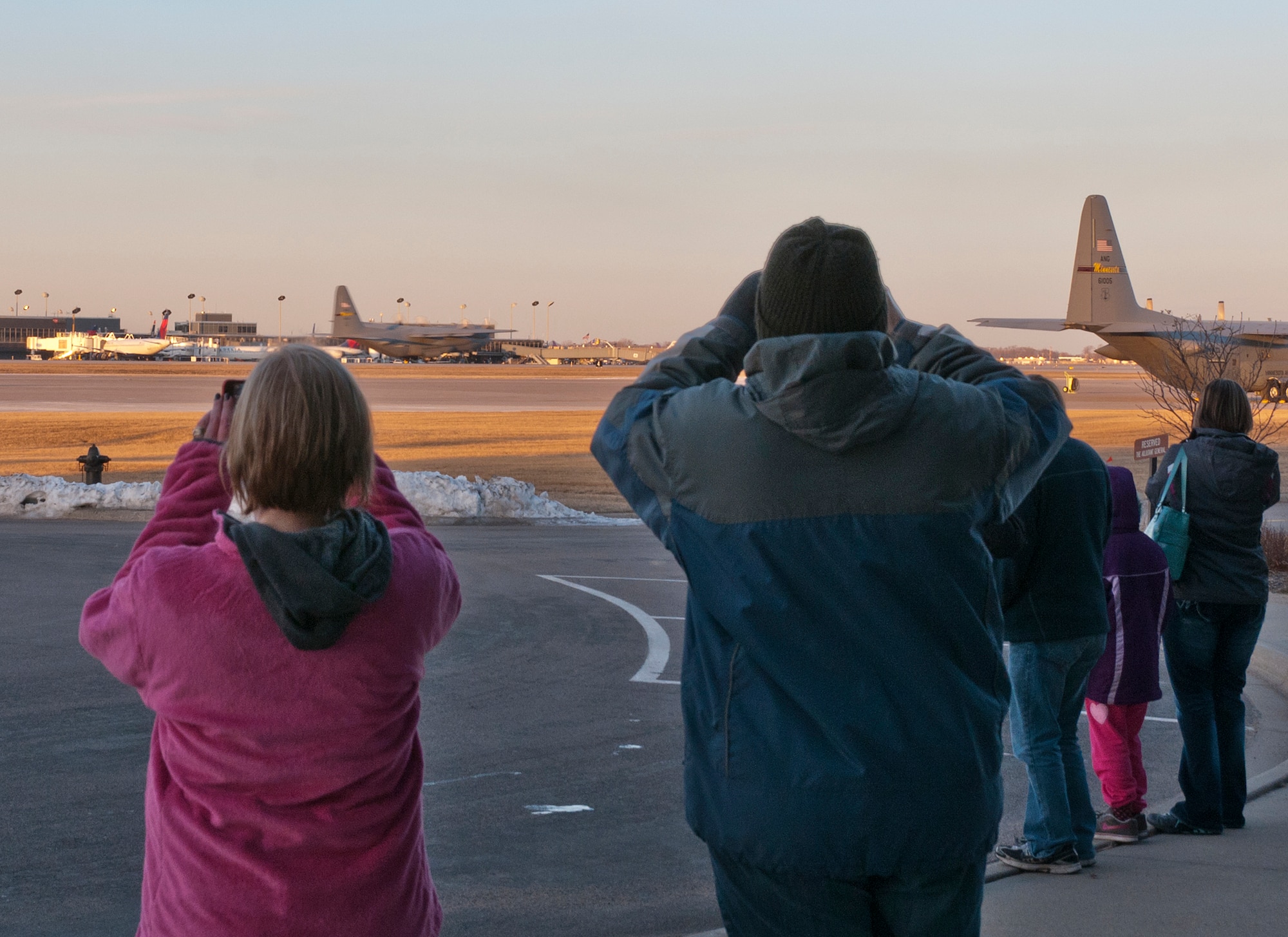 Family members watch a C-130 H3 “Hercules” take off with about 30 Minnesota Air National Guard Airmen to Afghanistan in support of Operation Enduring Freedom on March 9, 2012 at the St. Paul Air National Guard base. USAF official photo by Senior Master Sgt. Mark Moss