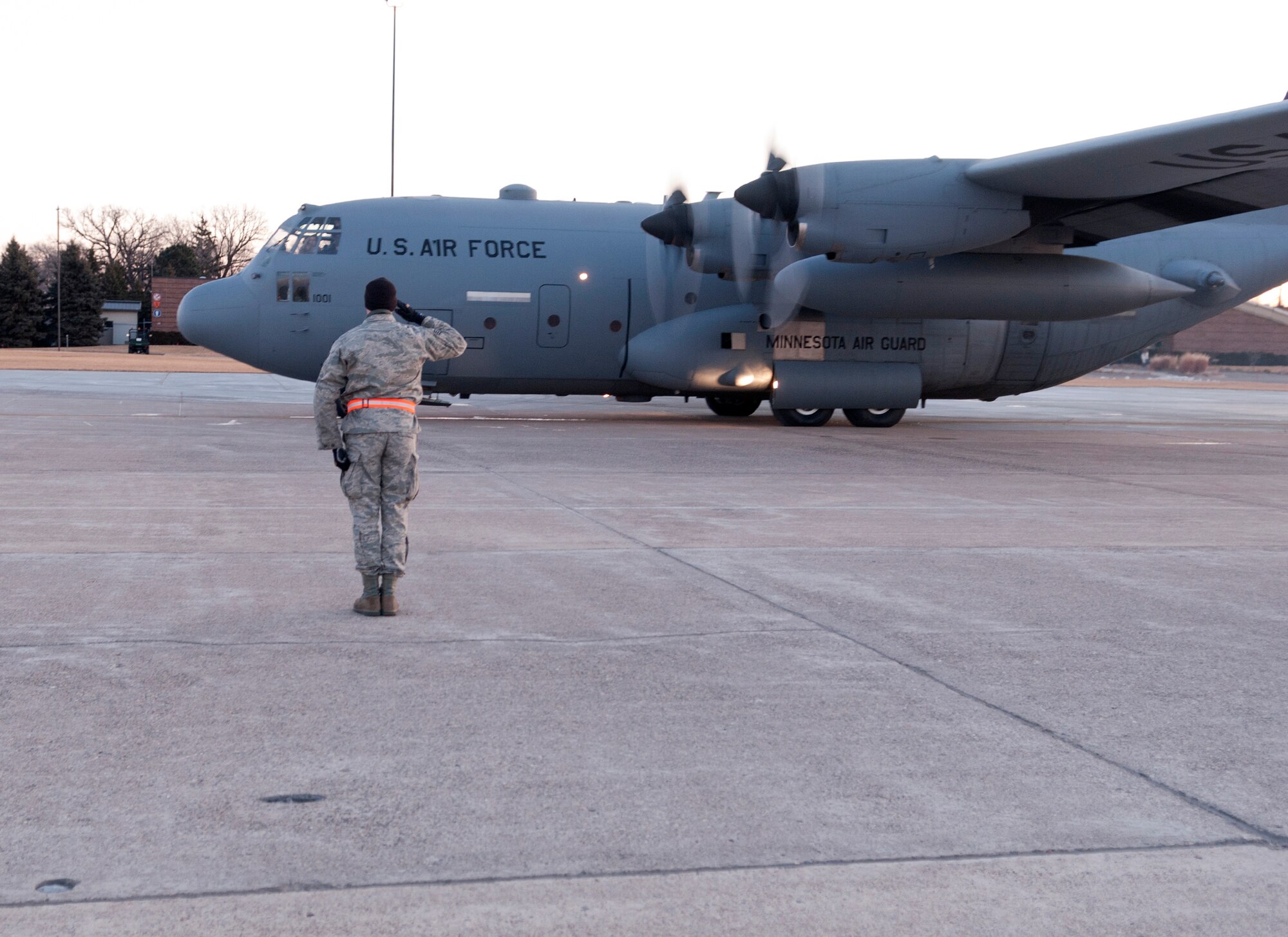 A crew chief salutes as a Minnesota Air National Guard C-130 H3 “Hercules” launches to Afghanistan in support of Operation Enduring Freedom on March 9, 2012 at the St. Paul Air National Guard base. USAF official photo by Senior Airman Jonathan Young