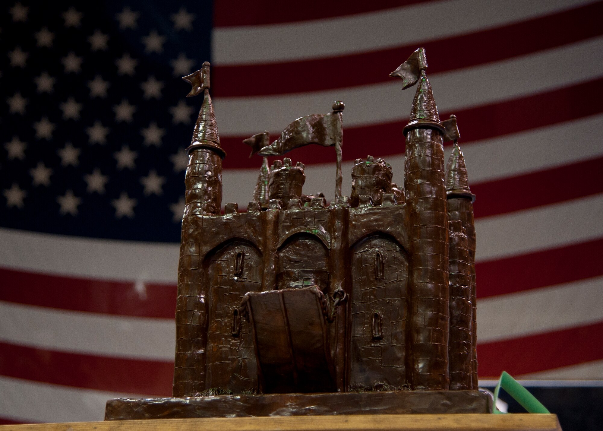 The Joint Base Langley-Eustis Culinary Arts Team showpiece during the 37th Annual Military Culinary Arts Competition at Fort Lee, Va., was a chocolate fondant castle. Adam Eudy, a 16-year-old student from South Carolina, assisted the team, and learned the rewards of teamwork during the competition. (U.S. Air Force photo by Senior Airman John Strong/ Released)