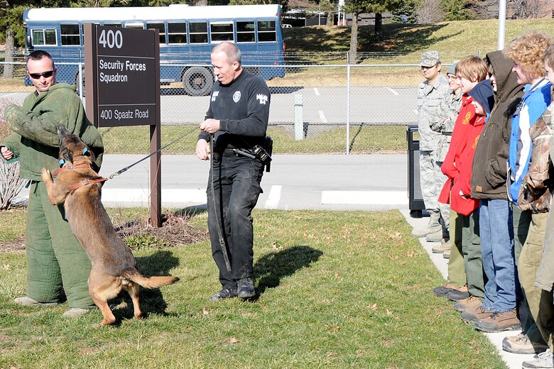 158 TSgt Jake Kelecava, of the 910 Security Forces, takes a bite from Fowler Police Officer Dave Blosser’s K-9, Vito. Watching the demonstration are members of Boy Scout Troop 99 out Newberry, Ohio.