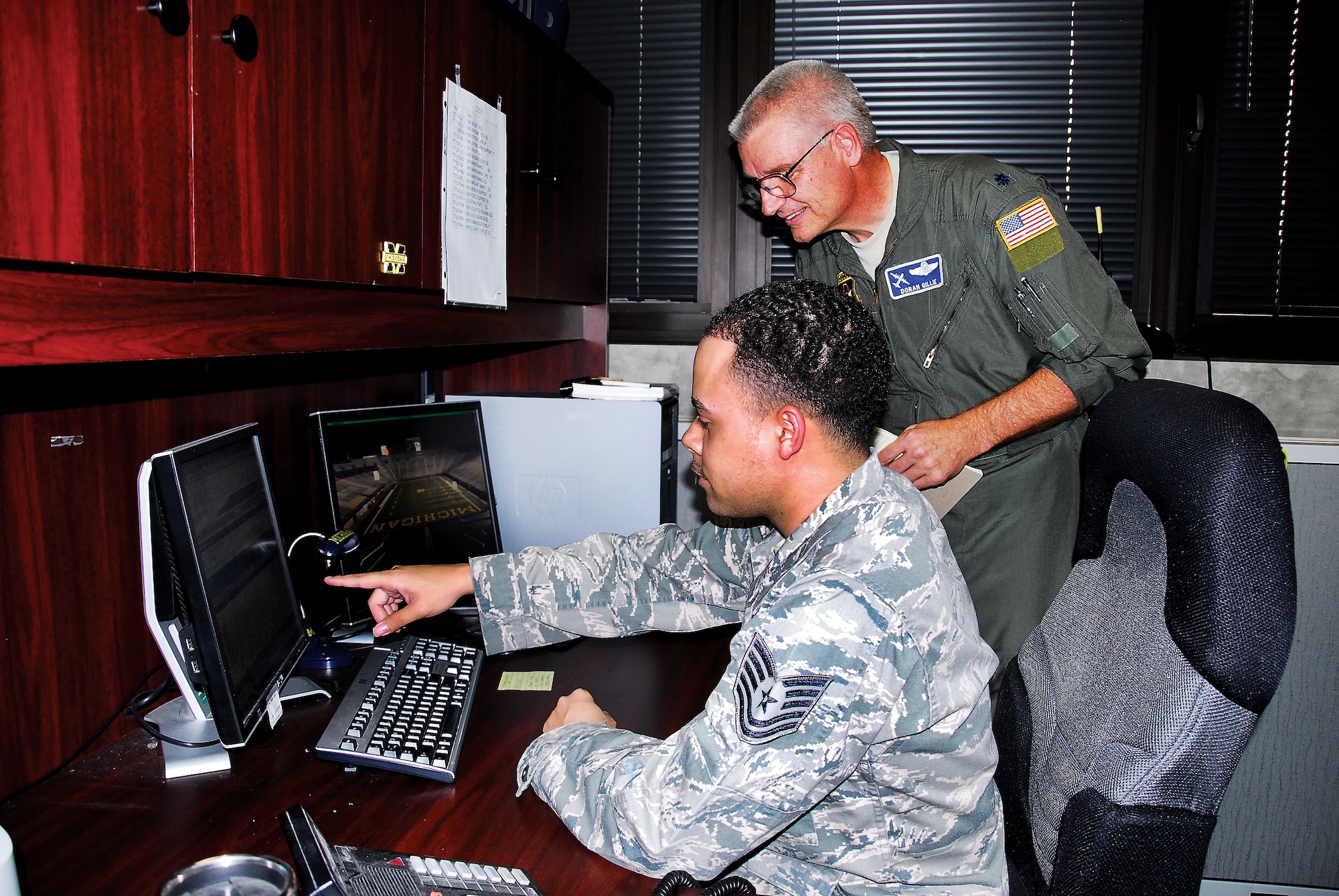 Tech. Sgt. Dwayne Curtis of LRS goes over his inspection checklist with Lt. Col. Doran Gillie, new chief of the Exercise Evaluation Team. (Air Force photo by Gene H. Hughes)