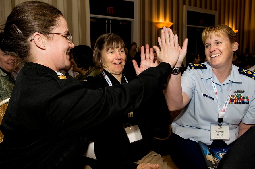 Lt. Cmdr. Erin Acosta, left, Capt. Erika Sauer, center, and Chief Warrant Officer Shawna Ward take part in a team building exercise during the Joint Women's Leadership Symposium Mar. 5, 2012, at the National Harbor in Washington, D.C. This event offered more than 1,700 women from all Service branches the opportunity to focus on professional and leadership development. (U.S. Air Force photo by Master Sgt. Jeanette Spain/Released)