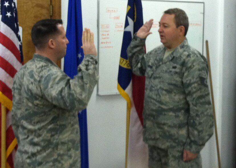 Maj. Dustin J. Pawlak (left) swears in Tech. Sgt. Michael L. Joyner during a re-enlistment ceremony during March drill weekend. Joyner is a member of the 916th Force Support Squadron, System Operation Flight. (USAF photo by TSgt William Opoku, 916FSS)