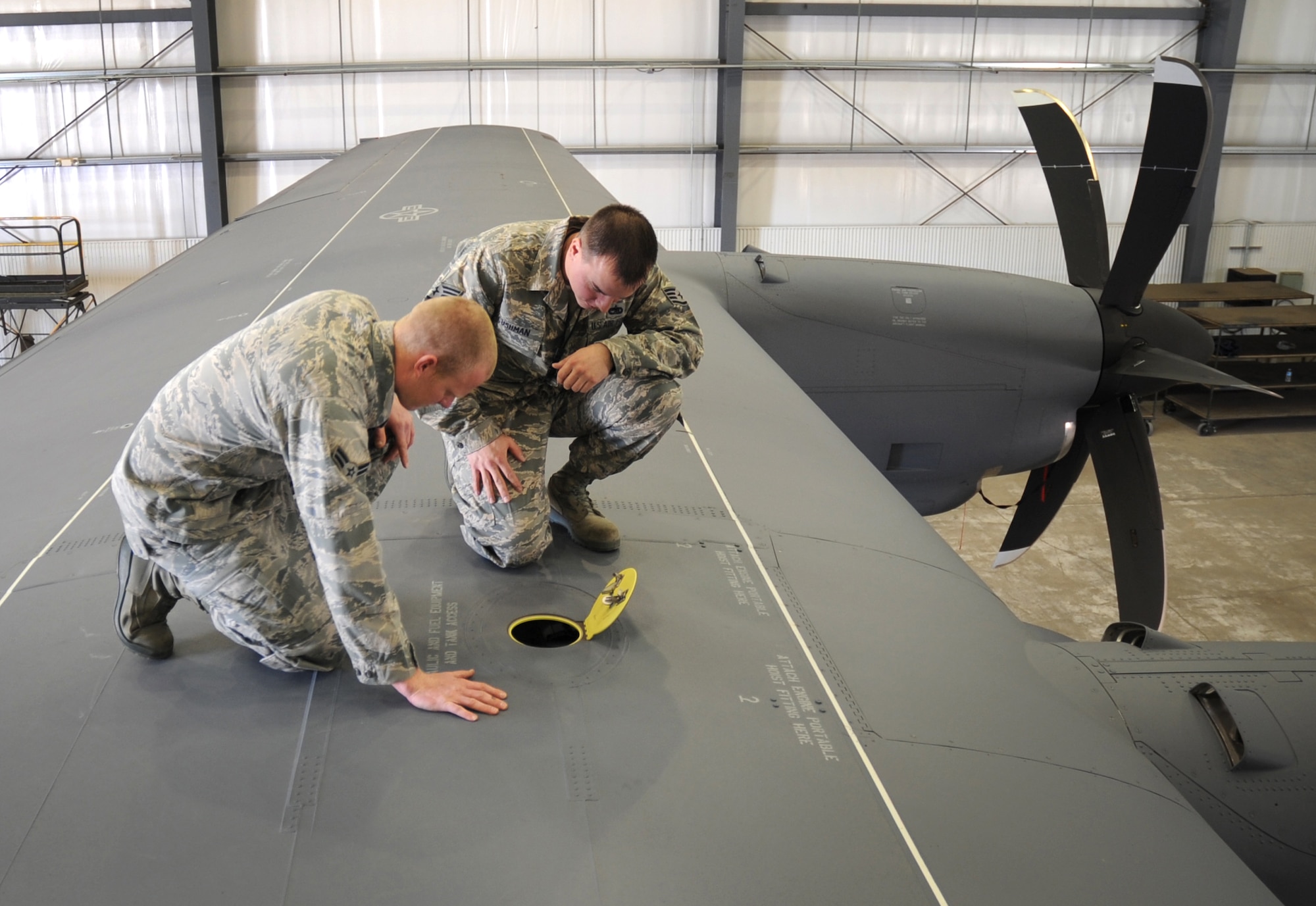 U.S. Air Force Staff Sgt. Shawn Cushman and Airman 1st Class Danny Beckwith, 522nd Special Operations Squadron crew chiefs, perform an inspection atop an MC-130J Commando II at Cannon Air Force Base, N.M., March 7, 2012. Crew chiefs must ensure aircraft configurations meet Air Force Special Operations Command standards before they are cleared for flight. (U.S. Air Force photo by Airman 1st Class Alexxis Pons Abascal) 