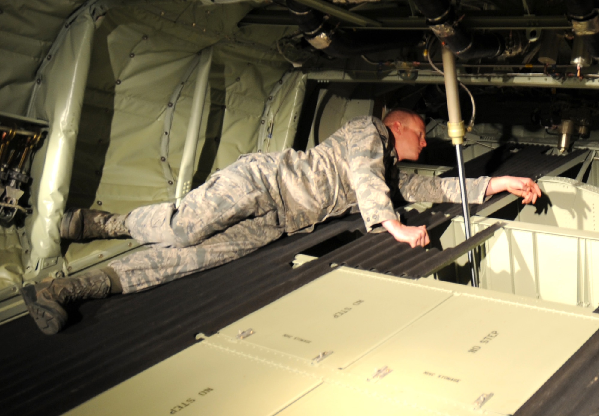 U.S. Air Force Airman 1st Class Danny Beckwith, 522nd Special Operations Squadron crew chief, checks the hydraulics system on the MC-130J Commando II at Cannon Air Force Base, N.M., March 7, 2012. Crew chiefs must ensure aircraft configurations meet Air Force Special Operations Command standards before they are cleared for flight. (U.S. Air Force photo by Airman 1st Class Alexxis Pons Abascal) 