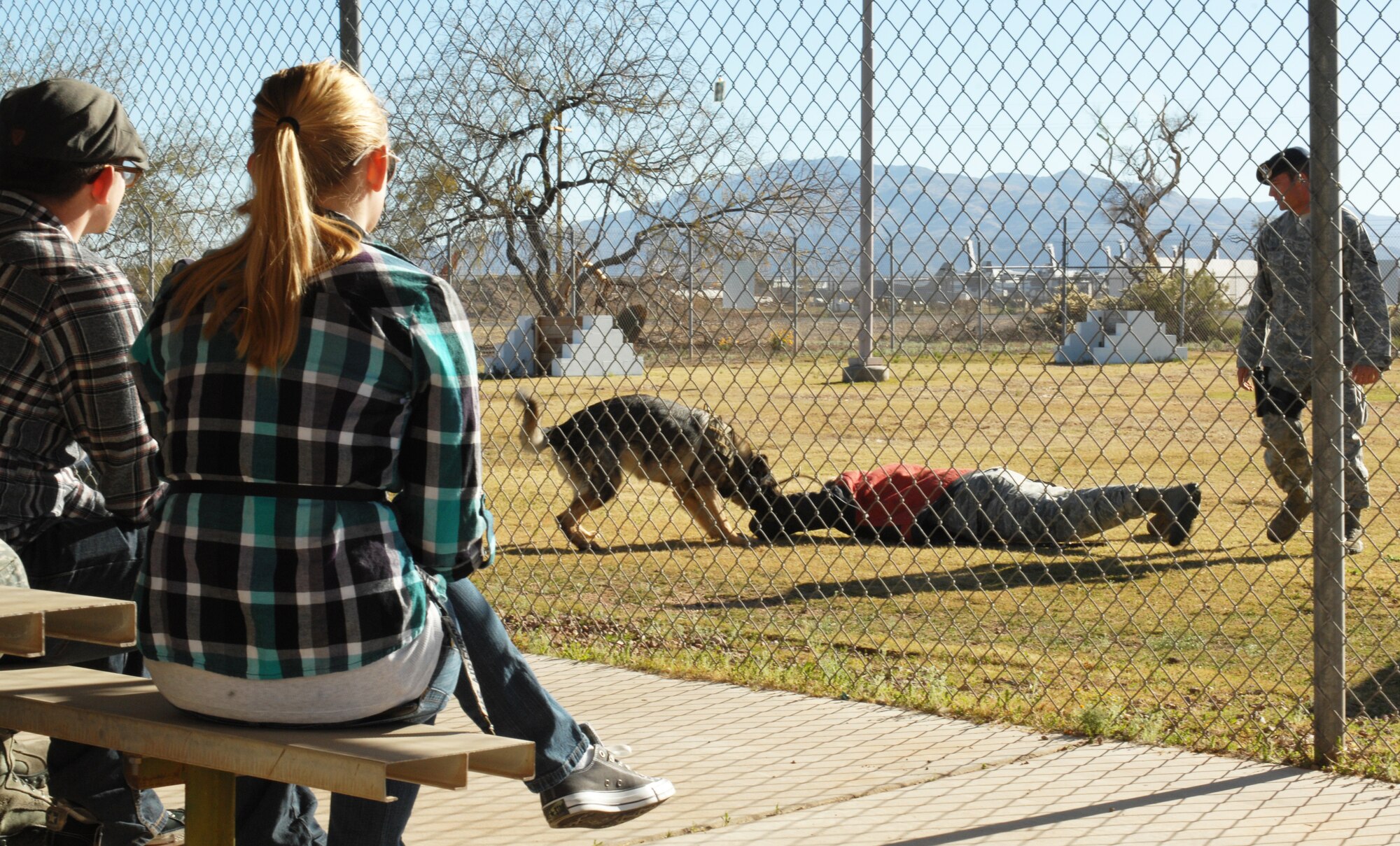 U.S. Air Force Staff Sgt. Robert Beaudon, 355th Security Forces Squadron military working dog handler, and his MWD Ceelo perform the proper procedures on an uncooperative “suspect” on Davis-Monthan Air Force Base, Ariz., Feb. 24. The demonstration was part of the Behind the Scenes tours, a Desert Lightning Team First Six Council-sponsored program that gives interested Airmen inside looks into different Air Force career fields. (U.S. Air Force photo by Airman 1st Class Saphfire Cook/Released)