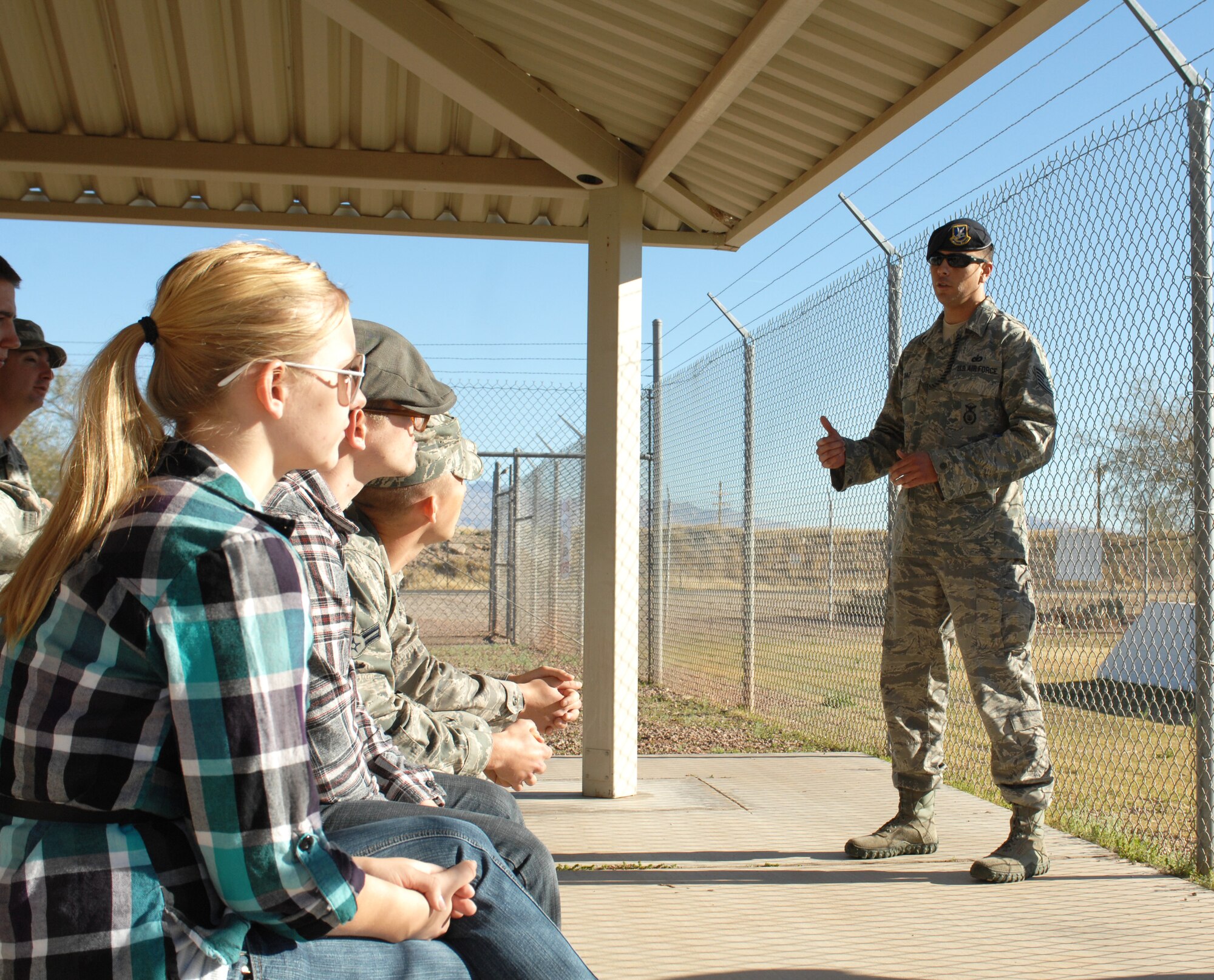 U.S. Air Force Tech. Sgt. Thomas Diaz, 355th Security Forces Squadron, gives a run-down of the demonstrations that will take place to the Behind the Scenes tour attendees on Davis-Monthan Air Force Base, Ariz., Feb. 24. Behind the Scenes tours are hosted by the Desert Lightning Team First Six Council and allow Airmen to experience an inside look at the different career fields the Air Force has to offer. (U.S. Air Force photo by Airman 1st Class Saphfire Cook/Released)