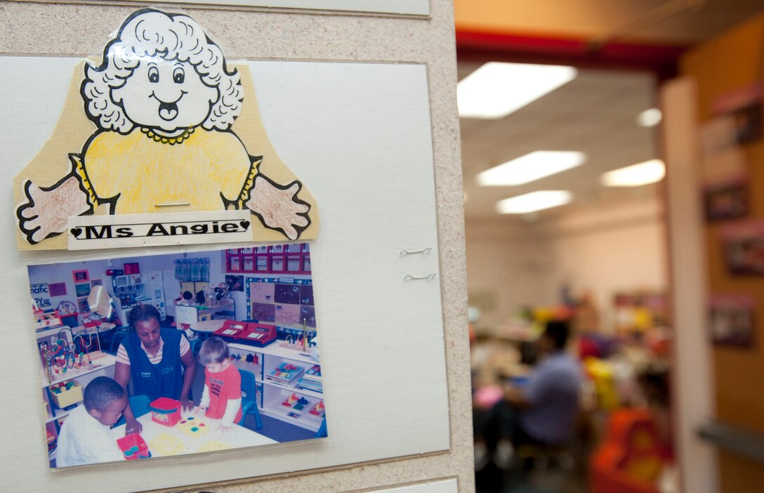 A photo of Angela Carrecter, Child Development Center program assistant, is displayed in front of her classroom on March 9, 2012 at Langley Air Force Base, Va.  Carrecter was awarded the WTKR News Channel 3 "Taking Action, Getting Results" award. (U.S. Air Force photo by Senior Airman Stephanie Rubi /Released)