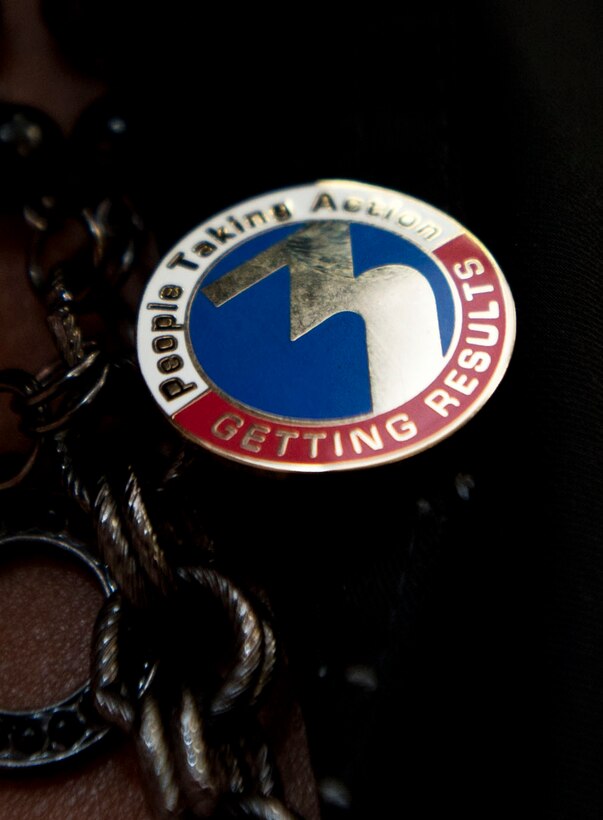 Angela Carrecter, Child Development Center program assistant, shows off her WTKR News Channel 3 pin after being awarded the "Taking Action, Getting Results" award on March 9, 2012 at Langley Air Force Base, Va. The pin is awarded to individuals making a difference in the local community.  (U.S. Air Force photo by Senior Airman Stephanie Rubi /Released)