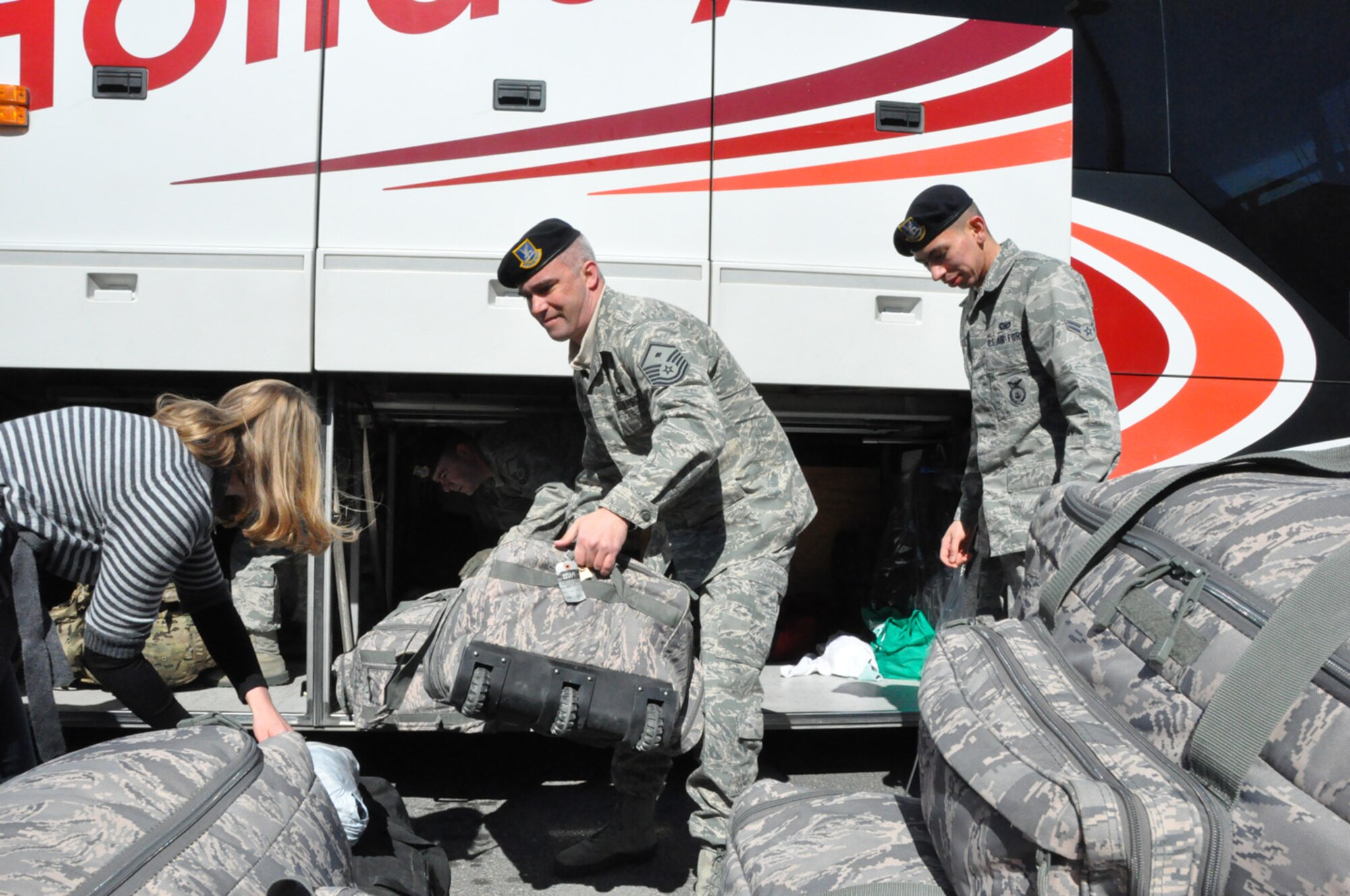 First Sergeant William Lester (center) helps returning Security Forces members with their bags in February 2012. Lester was named the 916th ARW's Outstanding First Sergeant of the Year for 2011. (USAF photo by MSgt. Wendy Lopedote, 916ARW/PA)