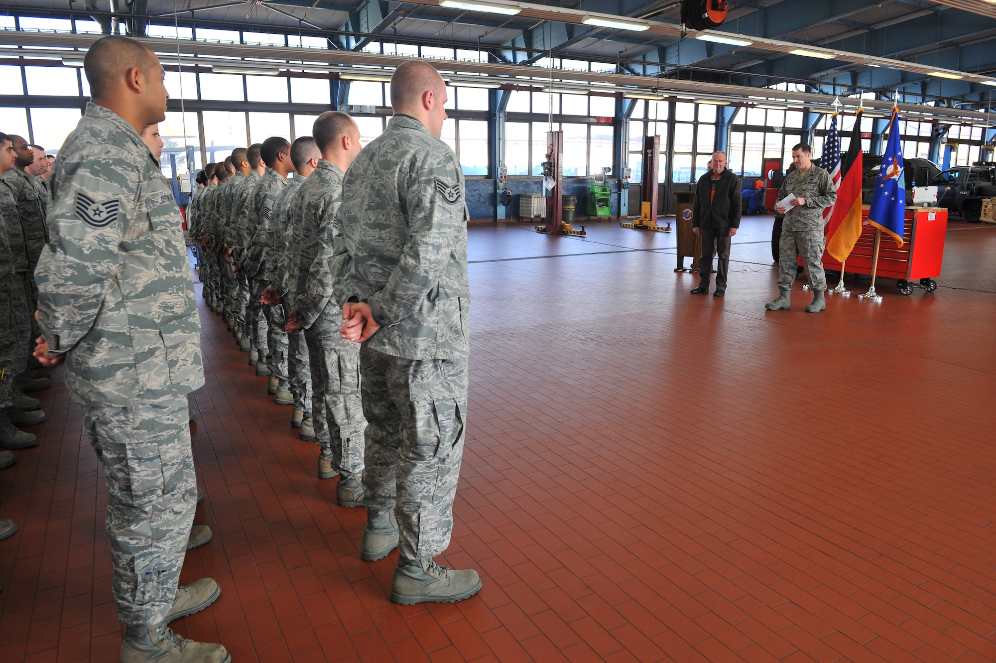 SPANGDAHLEM AIR BASE, Germany – Airmen from the 52nd Logistics Readiness Squadron stand in formation during a civilian length of service ceremony inside Bldg. 110 here March 9. The ceremony honored Mr. Hans Schinhofer, 52nd LRS lead vehicle operator, for his 35 years of service to Spangdahlem AB. Distinguished visitor Chief Master Sgt. Billy Davis, vehicle operations career field manager, took time to participate in the ceremony, as well as to discuss upcoming changes in the career field and answer questions. (U.S. Air Force photo by Airman 1st Class Dillon Davis/Released)