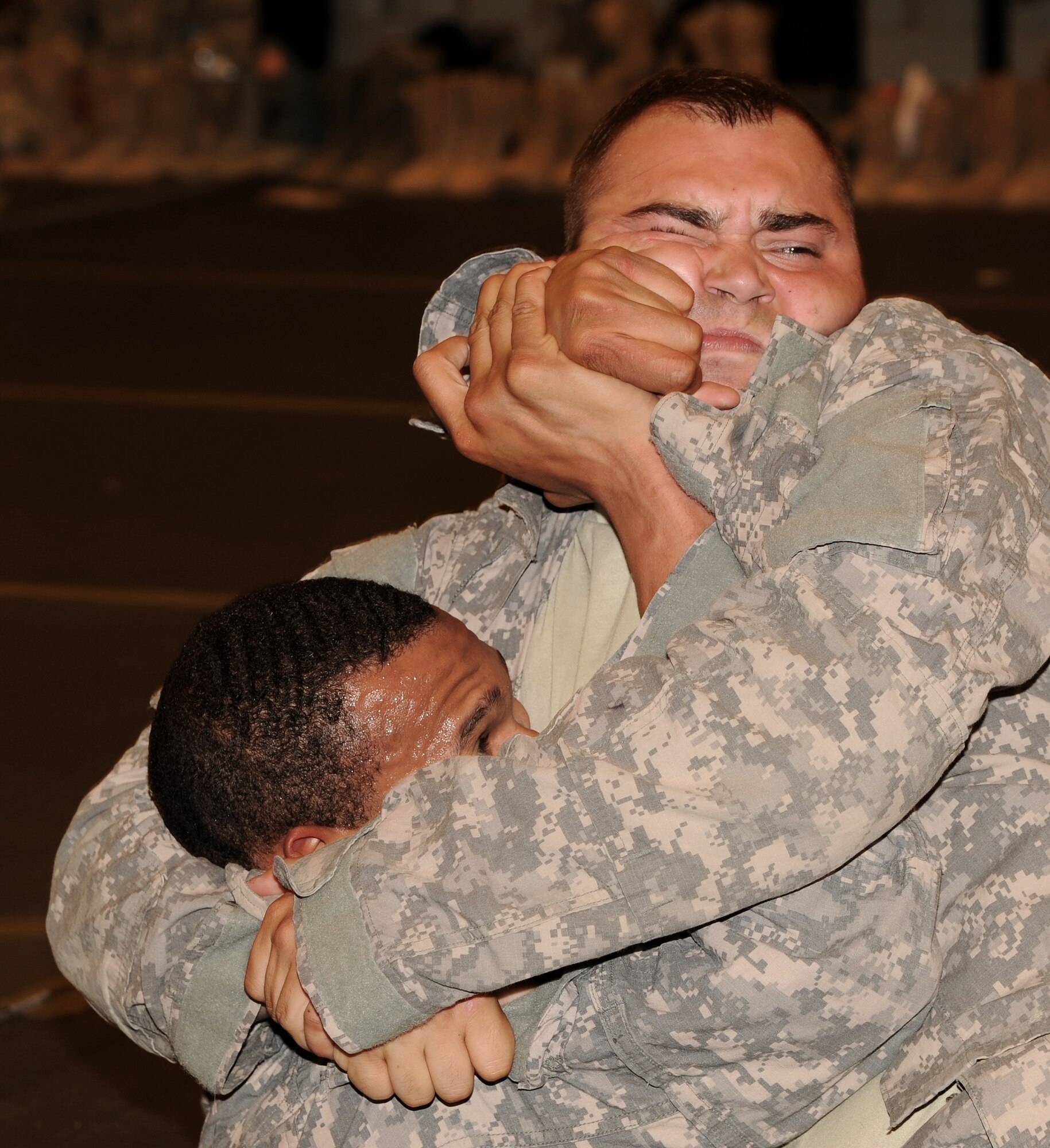 SOUTHWEST ASIA - U.S. Army Spc. Douglas Smith traps U.S. Army Sgt. Anthony King in an arm lock at the Phantom Center March 9, 2012. Airmen and Soldiers from the 380th Air Expeditionary Wing trained during a combatives course to learn 18 different self-defense techniques. At the end of 40 hours of instruction, each graduate was certified as a basic combatives instructor. Smith and King are both assigned to the 3rd Battalion, 4th Air Defense Artillery Regiment and are deployed from Fort Bragg, N.C. (U.S. Air Force photo/Tech. Sgt. Arian Nead)