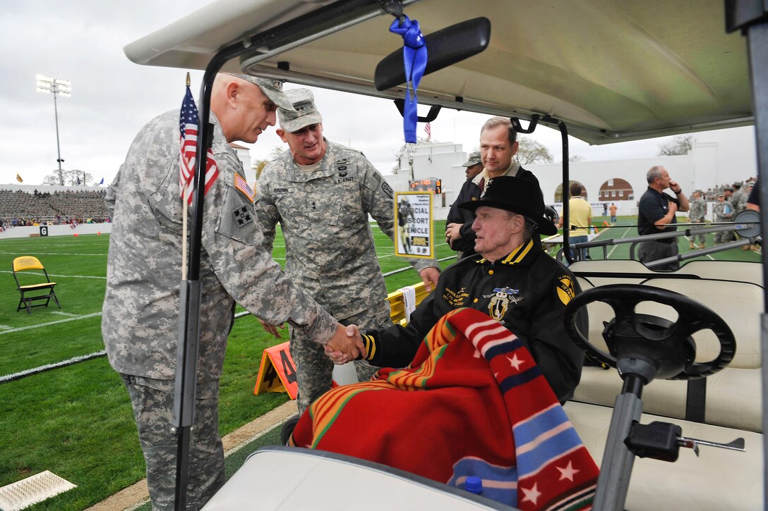 Army Chief of Staff Gen. Raymond T. Odierno and Maj. Gen. Robert B. Brown meet retired Lt. Gen.Harold "Hal" Moore Jr.  at Doughboy Stadium on Fort Benning, Ga., March 9, 2012, during the annual U.S. Military Academy at West Point spring scrimmage known as the "Black and Gold" game. 
