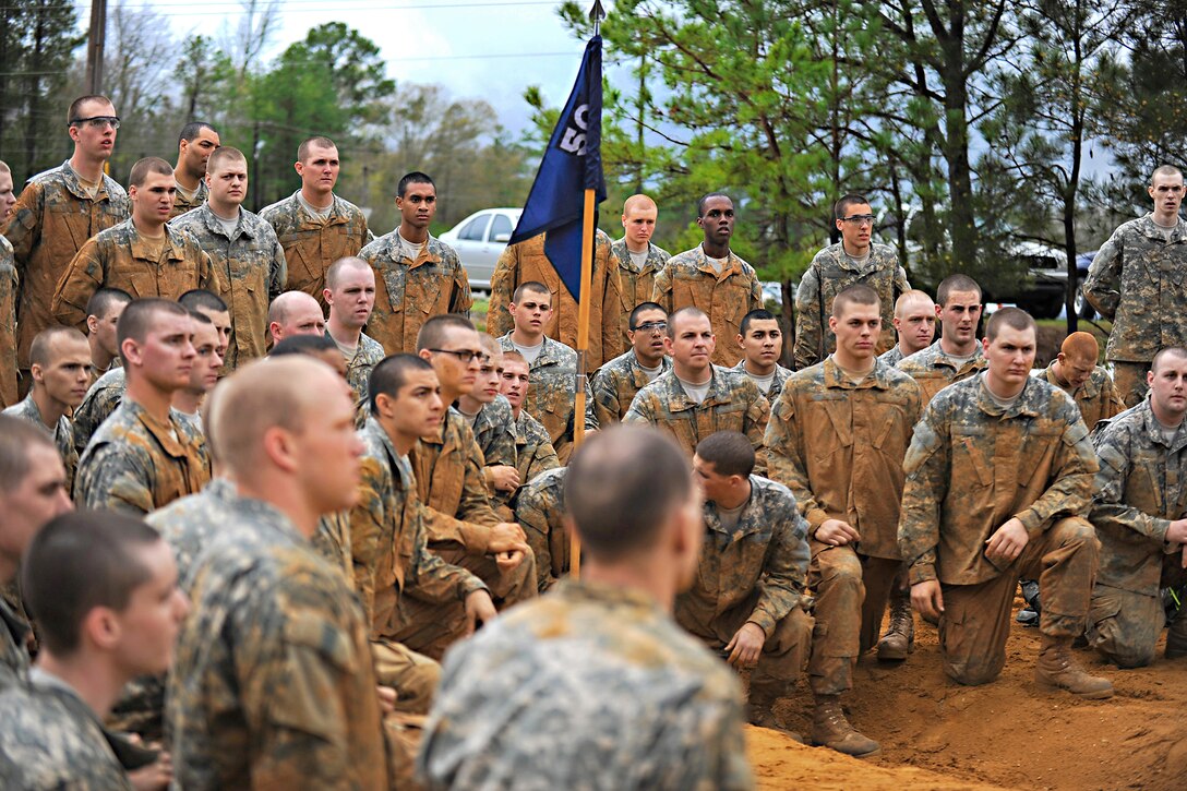 Soldiers take a break after completing an obstacle course during their first week of basic combat training on Fort Benning, Ga., March 9, 2012.