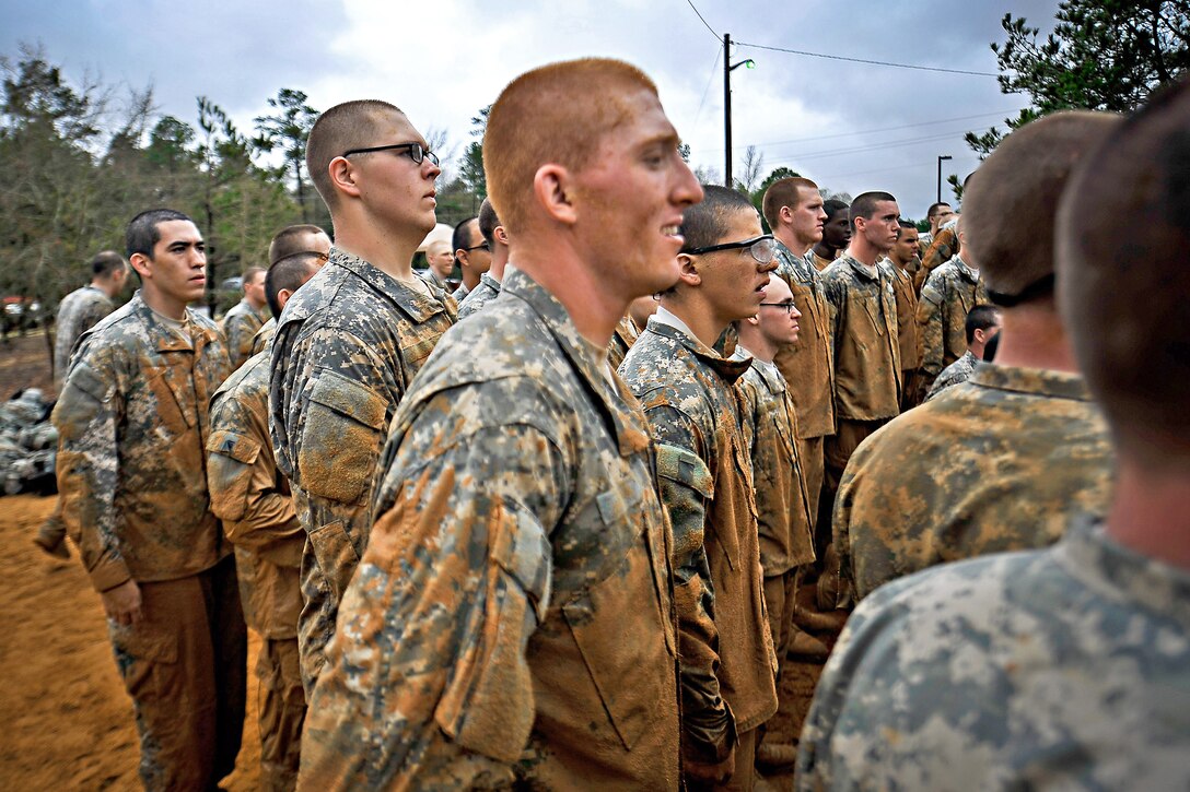 Soldiers stand at attention after completing an obstacle course during their first week of basic combat training on Fort Benning, Ga., March 9, 2012.