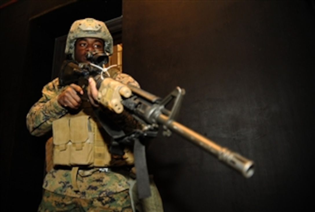 U.S. Marine Corps Lance Cpl. Tyrone Wilkes, assigned to Fleet Antiterrorism Security Team Company Pacific, 2nd Platoon, stands guard while fellow Marines simulate the recapturing of a building at Camp Rodriguez, South Korea, on March 7, 2012.  More than 50 Marines assigned to 2nd Platoon are training at the Camp Rodriguez live fire complex during Fleet Antiterrorism Security Team Exercise 2012 to sustain and improve weapons marksmanship.   