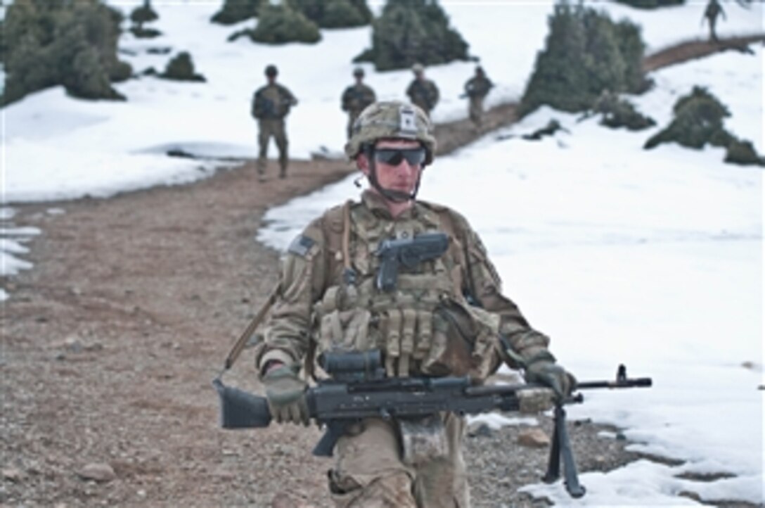 U.S. Army Pfc. Cristian Franco, assigned to 3rd Battalion, 509th Infantry Regiment, carries an M240B machine gun while descending a mountain path during a security patrol overlooking the Pesho Ghar valley and the Enzarkay Pass in Paktya province, Afghanistan, on March 2, 2012.  
