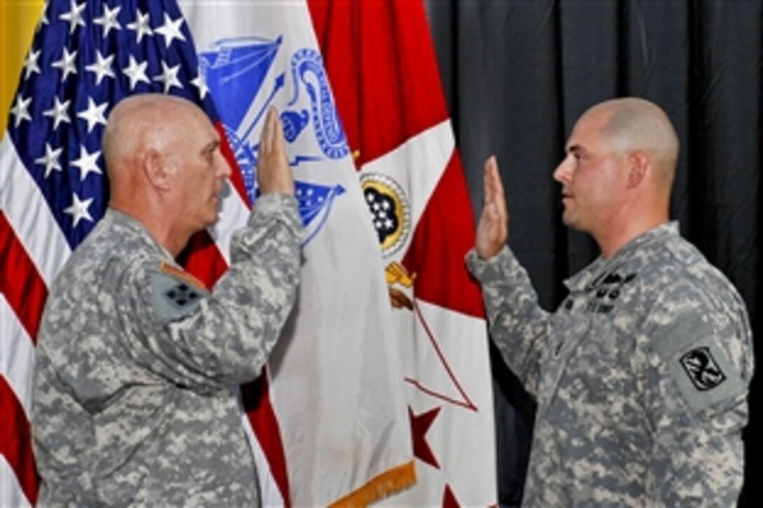 Army Chief of Staff Gen. Raymond T. Odierno administers the oath of enlistment to Sgt. 1st Class Phillip Richards III during a re-enlistment ceremony on Fort Benning, Ga., March 9, 2012. Richards is a drill sergeant assigned to Company F, 1st Battalion, 50th Infantry Regiment, 198th Infantry Brigade.