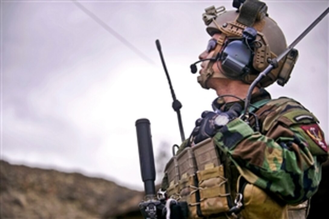 A combat controller coordinates close air support during a firefight in which coalition and Afghan commandos joined forces in the Sar Kani district of Afghanistan's Kunar province, March 7, 2012.