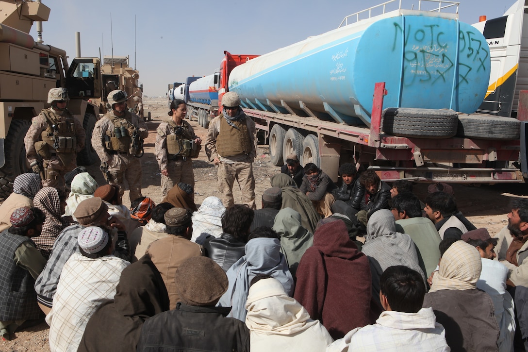 First Lt. Mariela Pena, center, 2nd Platoon Commander, General Support Motor Transport Company, Marine Air-Ground Task Force Support Battalion 11.2, 1st Marine Logistics Group (Forward) explains the rules and regulations through an interpreter to 35 local Afghan truck drivers outside of Camp Leatherneck, Afghanistan, March 11. The 2nd platoon Marines provided an escort for Afghan drivers who hauled approximately 340,000 gallons of fuel to forward operating bases in northern Helmand province.