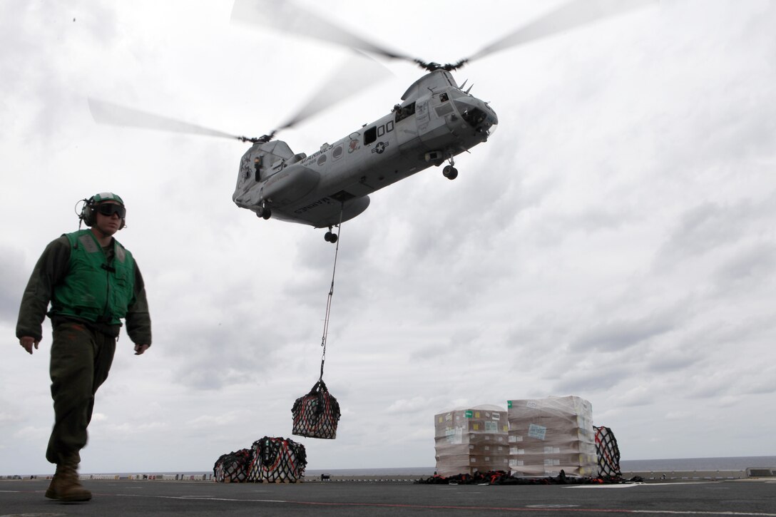 A CH-46E Sea Knight helicopter with Marine Medium Helicopter Squadron 265 (Reinforced), 31st Marine Expeditionary Unit, delivers supplies to the USS Essex (LHD 2), during a resupply at sea, March 13. The 31st MEU is conducting its Certification Exercise, which certifies the MEU to perform actual contingency operations during its upcoming deployment. The 31st MEU is the only continuously forward-deployed MEU and remains the nation’s force in readiness in the Asia-Pacific region.