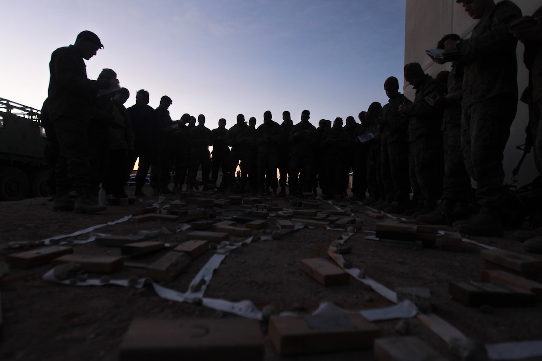 Marines in the Infantry Officers Class circle around a terrain map as they are brief on the day's exercise at Range 220 March 14, 2012.