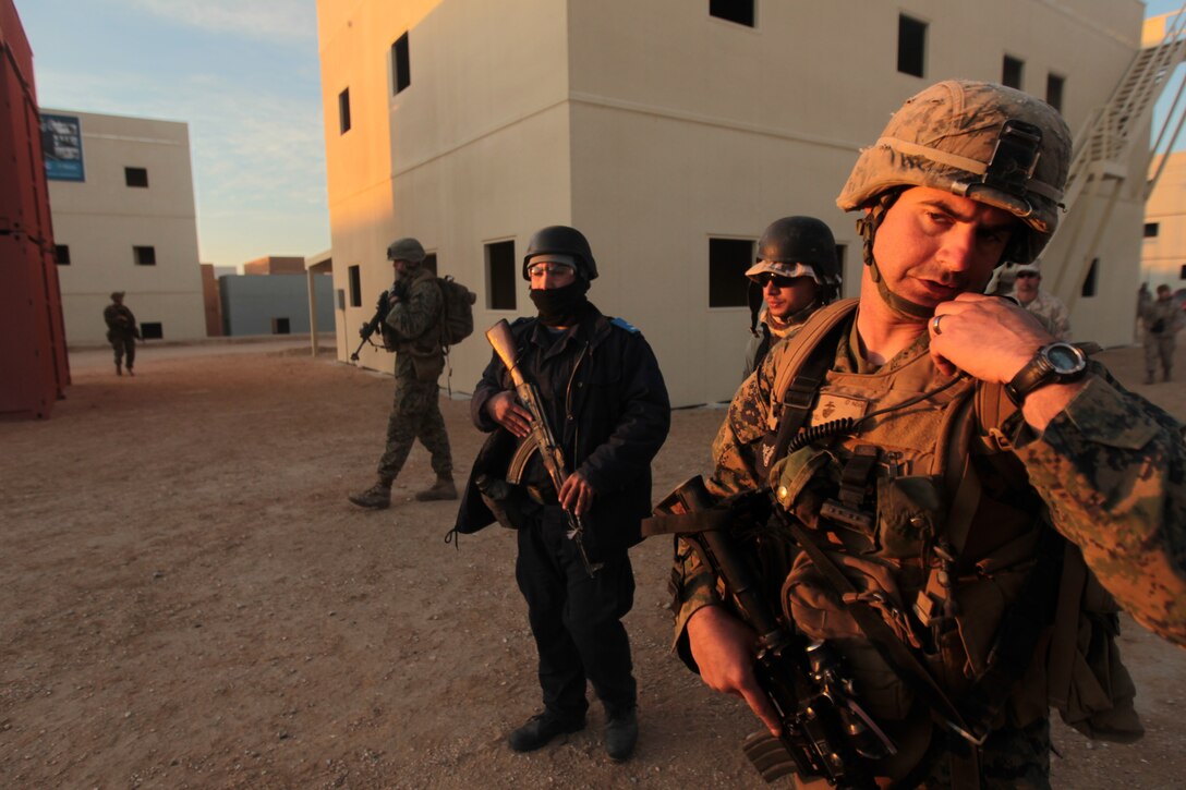 2nd Lt. Altan Kandiyeli, student, Infantry Officers Course, speaks over his radio during exercises for the IOC at Range 220 March 14, 2012.::r::::n::