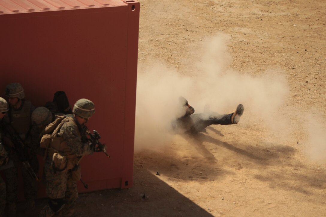A role player playing the part of an sucicide bomber dressed as an Afghan police officer explodes with white powder, creating simulated casualties during exercises for the Infantry Officers Course at Range 220 March 14, 2012.