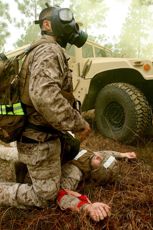 A Marine with 2nd Maintenance Battalion, 2nd Marine Logistics Group provides aid to a simulated casualty during a competition aboard Camp Lejeune, N.C., March 13, 2012. The casualty was located, treated and evacuated during the combat lifesaver skills portion of the super squad event.  (U.S. Marine Corps photo by Cpl. Katherine M. Solano)