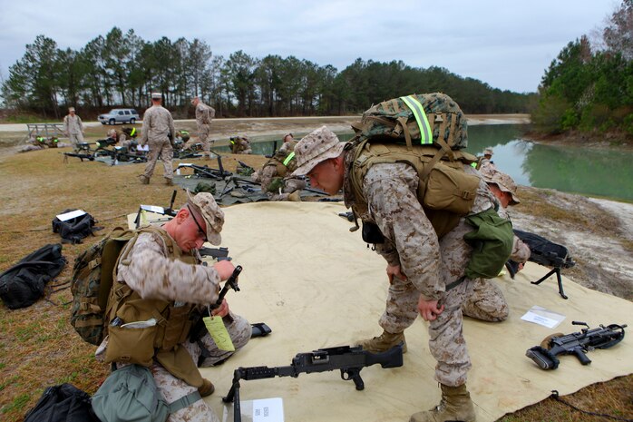 Sgt. Nicholas Safran (kneeling left), a squad leader for general support maintenance, 2nd Maint. Battalion, 2nd Marine Logistics Group, assembles an assault-style weapon during a super squad competition aboard Camp Lejeune, N.C., March 13, 2012.  After assembling the designated weapons, the squads raced on to the next leg of the course where they competed in Marine Corps Martial Arts Program drills.  (U.S. Marine Corps photo by Cpl. Katherine M. Solano)
