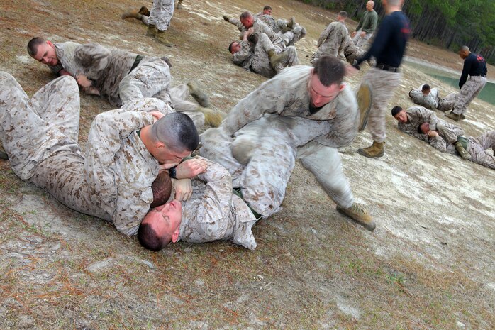 Marines with 2nd Maintenance Battalion, 2nd Marine Logistics Group utilized their Marine Corps Martial Arts Program skills during a super squad competition aboard Camp Lejeune, N.C., March 13, 2012.  The winning squad moved on to the next leg of the course, while the losers had to stay behind and take on the next squad.  (U.S. Marine Corps photo by Cpl. Katherine M. Solano)