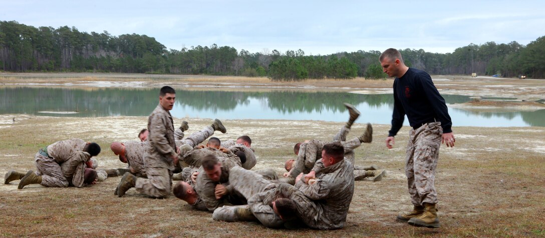 Marines with 2nd Maintenance Battalion, 2nd Marine Logistics Group use their Marine Corps Martial Arts Program skills during a squad competition aboard Camp Lejeune, N.C., March 12, 2012.  The objective was to beat the opposing squad in order to move on to the combat fitness test, which was the last station in the competition.  (U.S. Marine Corps photo by Cpl. Katherine M. Solano)