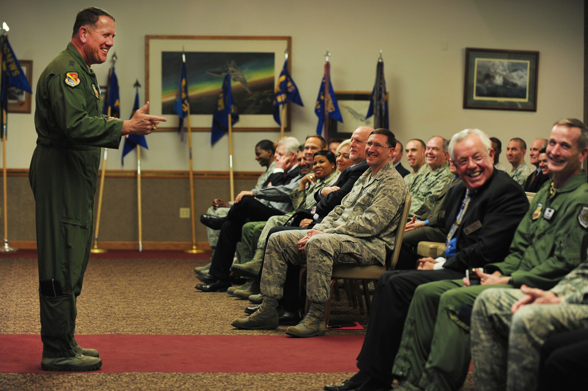 U.S. Air Force Maj. Gen. James Hyatt, U.S. Air Force Warfare Center commander, shares a laugh with members of the Nellis Support Team and new honorary commanders during a commander's call at Nellis Air Force Base, March 9, 2012.  Maj. Gen. Hyatt expanded on upcoming and current projects affecting the Nellis and Las Vegas community and answered questions from attendees.  (U.S. Air Force photo by Staff Sgt. William P.Coleman)