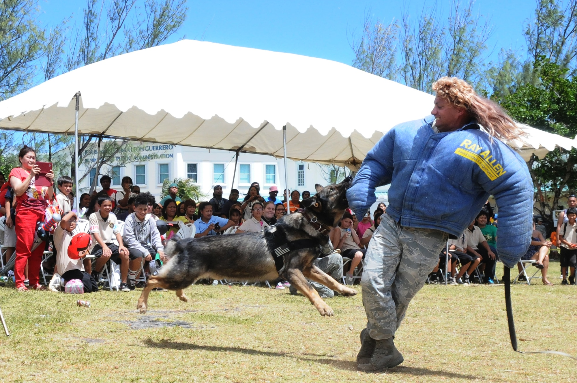 ANDERSEN AIR FORCE BASE, Guam - Mike, a military working dog, clamps on to a suspect during a training demonstration at the University Of Guam, March 13. When given commands from the handler, Mike will release the suspect and sit. Should the suspect try to run again, the dog will immediately attack. (U.S. Air Force photo/Senior Airman Carlin Leslie)
