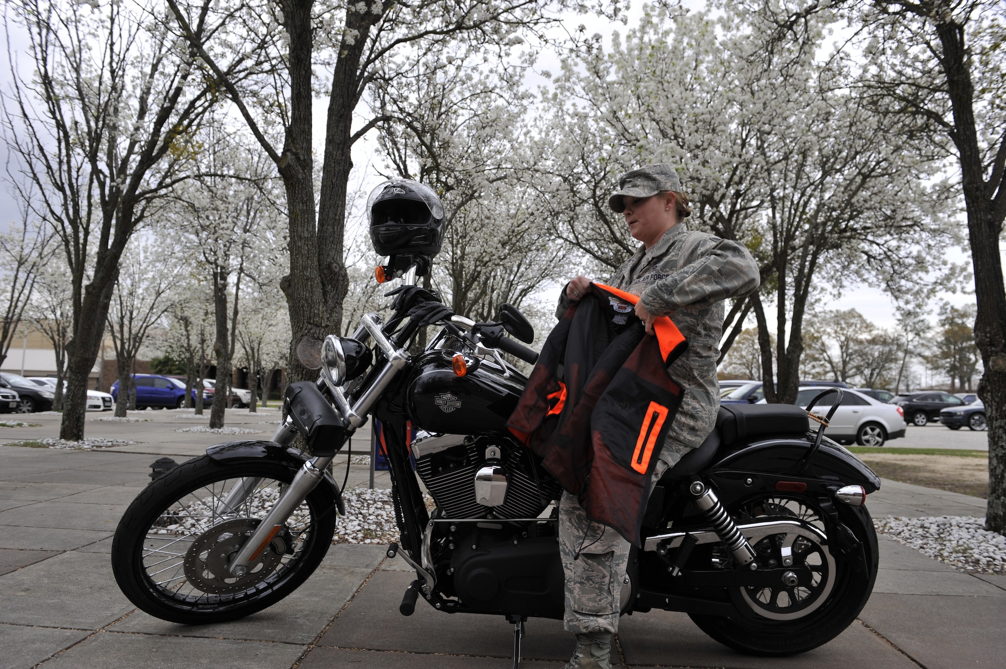 SHAW AFB - U.S. Air Force Staff Sgt. Cassandra Jenniges, a native of Lamberton, Minn., and currently assigned to the 20th Force Support Squadron, 20th Fighter Wing, Shaw Air Force Base, S.C. puts on her reflective riding jacket before riding her motorcycle on March 9, 2012, while at Shaw AFB, S.C.  (U.S.  Air Force photo by Airman 1st Class Ashley L. Gardner/Released)